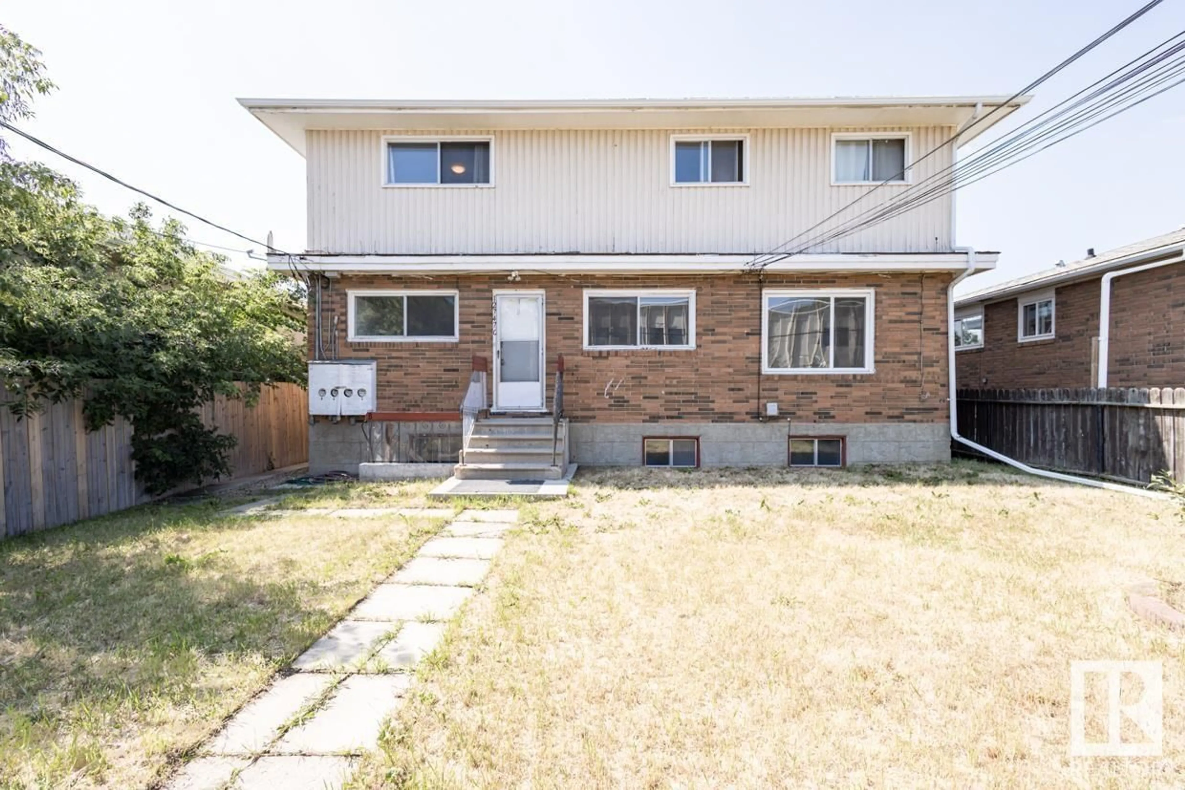 A pic from exterior of the house or condo, the fenced backyard for 12747 128 ST NW, Edmonton Alberta T5L1E2