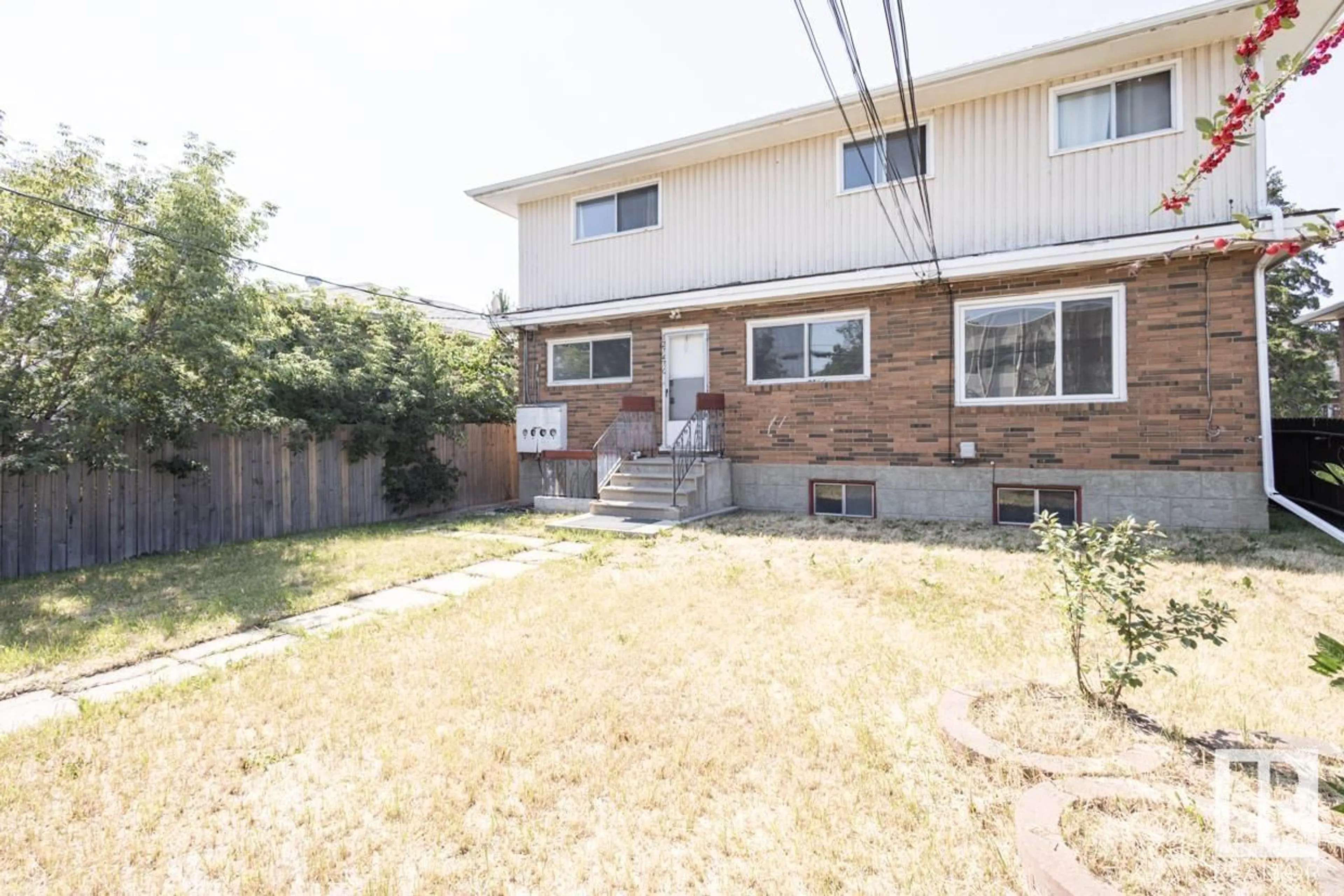 Frontside or backside of a home, the fenced backyard for 12747 128 ST NW, Edmonton Alberta T5L1E2