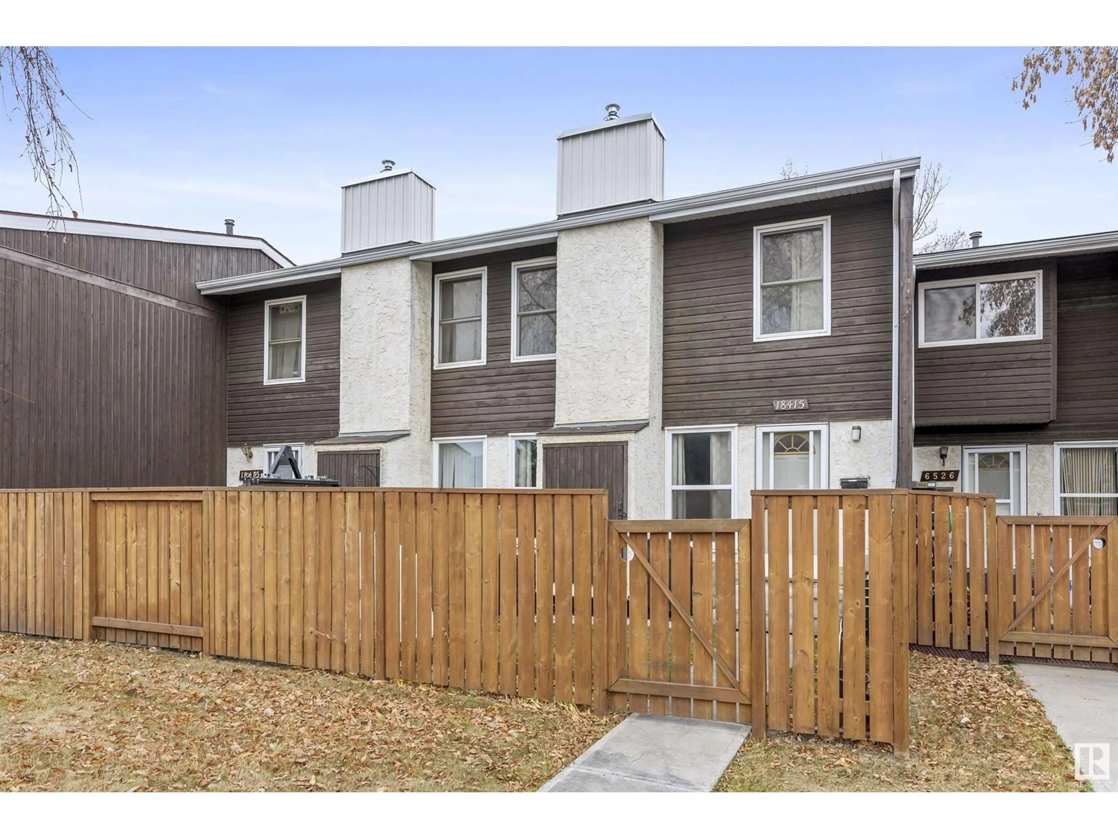 A pic from exterior of the house or condo, the fenced backyard for 18415 66 AV NW, Edmonton Alberta T5T2M1