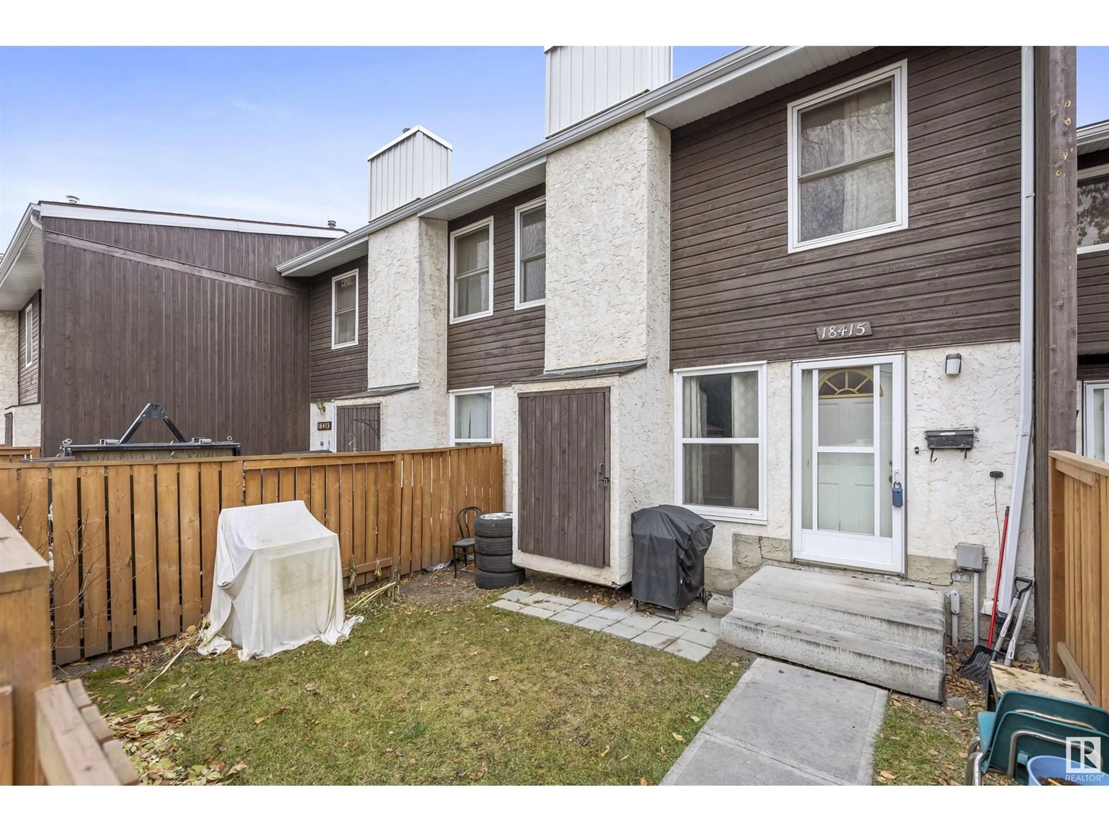 A pic from exterior of the house or condo, the fenced backyard for 18415 66 AV NW, Edmonton Alberta T5T2M1