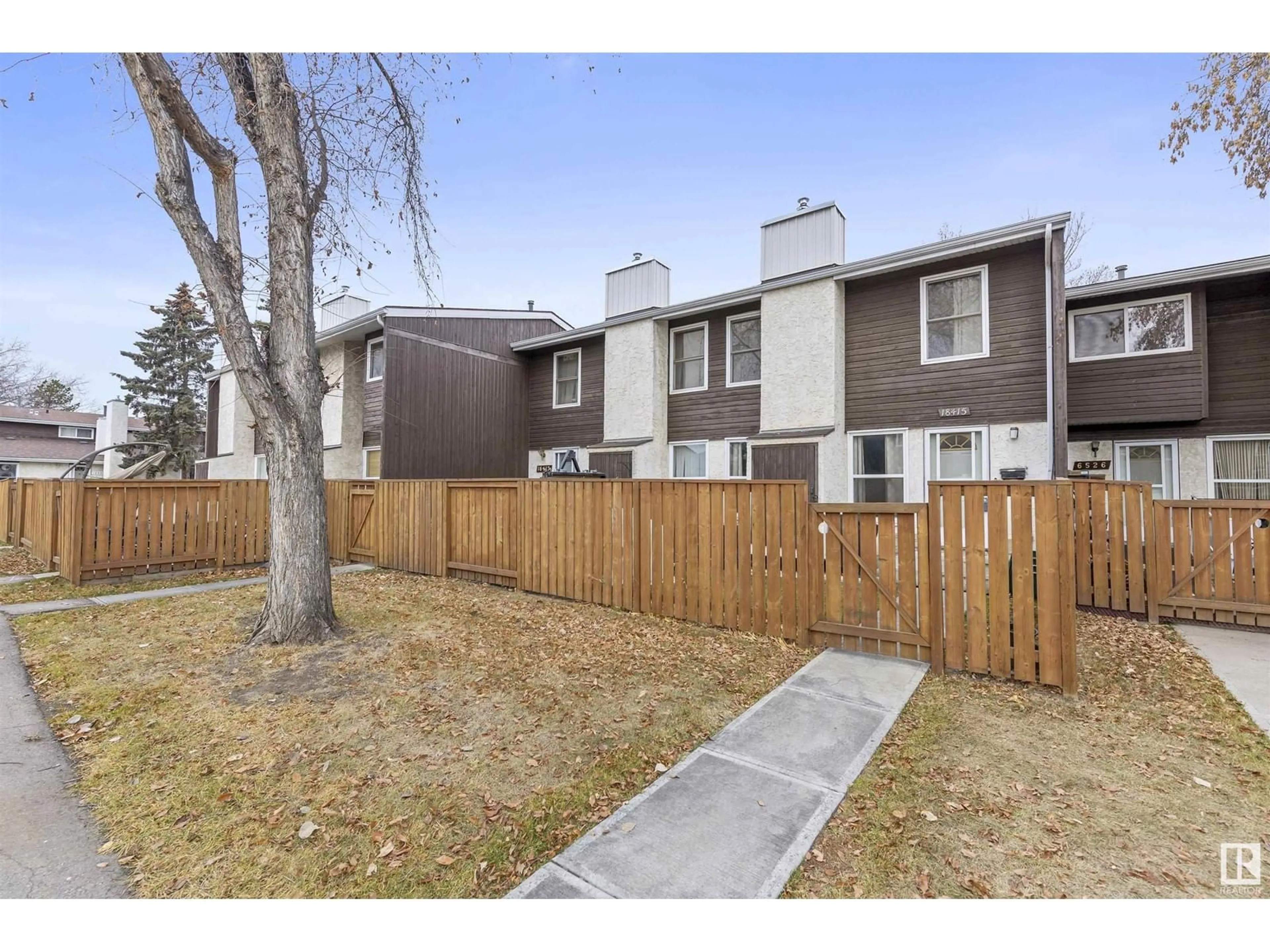 A pic from exterior of the house or condo, the fenced backyard for 18415 66 AV NW, Edmonton Alberta T5T2M1