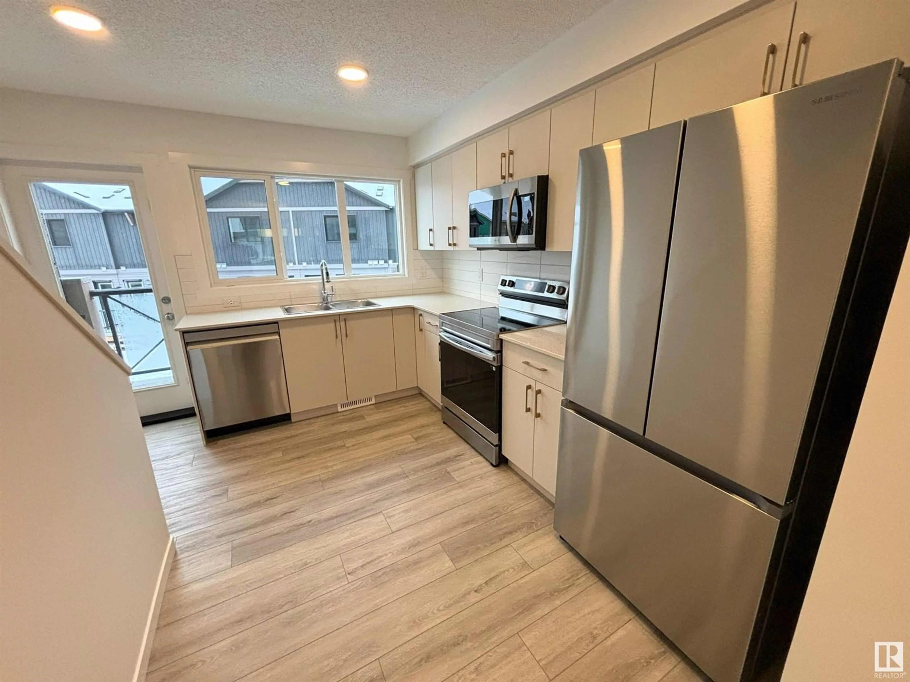 Open concept kitchen for #116 1025 SECORD PROMENADE NW, Edmonton Alberta T5T7V4