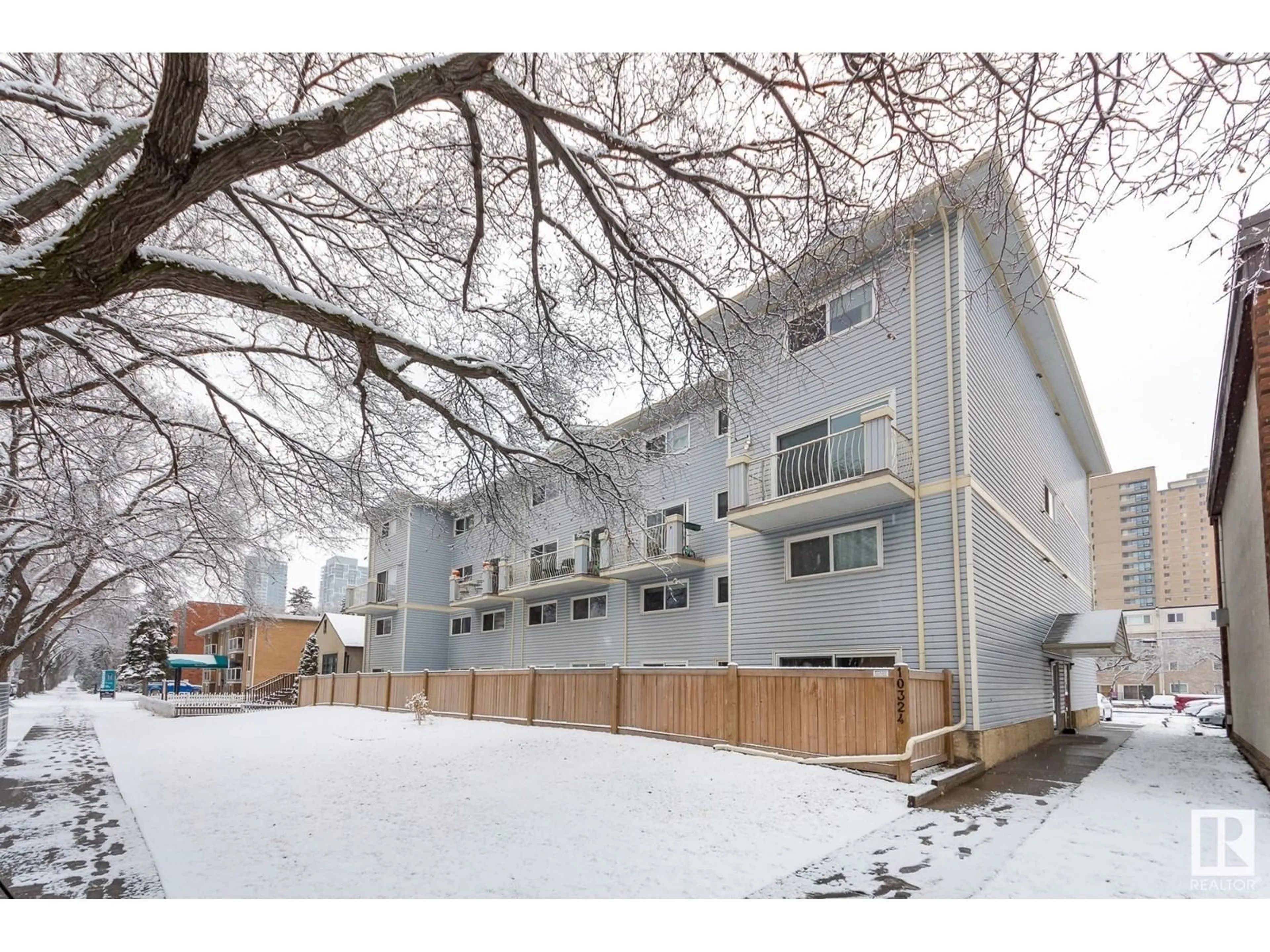 A pic from exterior of the house or condo, the fenced backyard for #11 10324 119 ST NW, Edmonton Alberta T5K1Z6