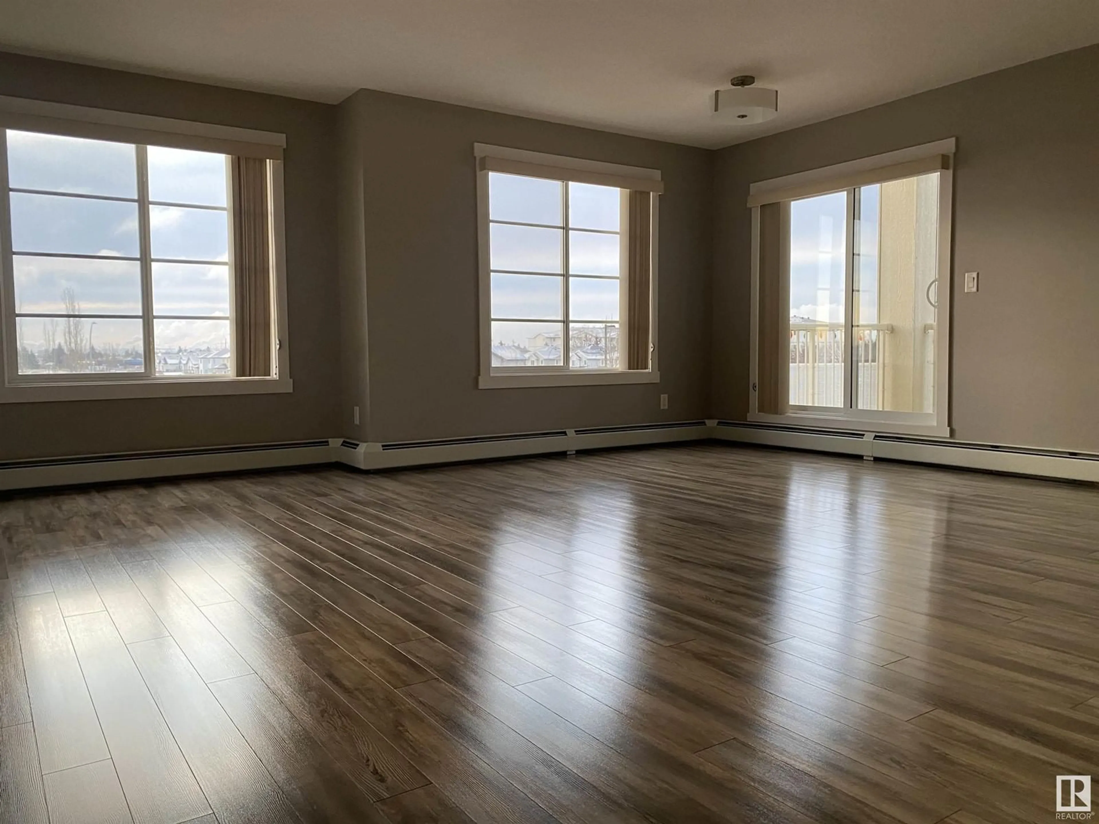 A pic of a room, wood floors for #319 3670 139 AV NW NW, Edmonton Alberta T5Y3N5