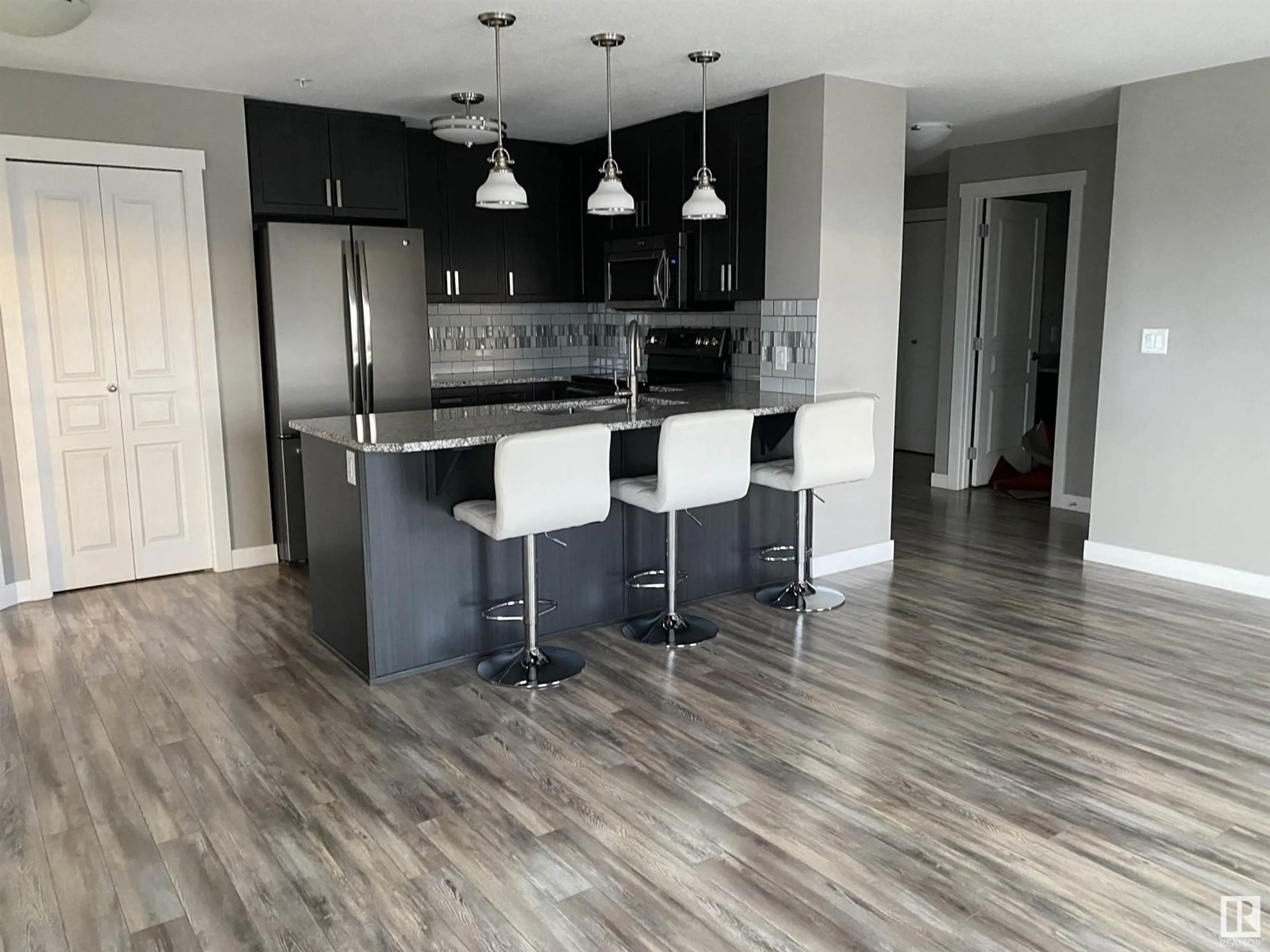 Open concept kitchen for #319 3670 139 AV NW NW, Edmonton Alberta T5Y3N5