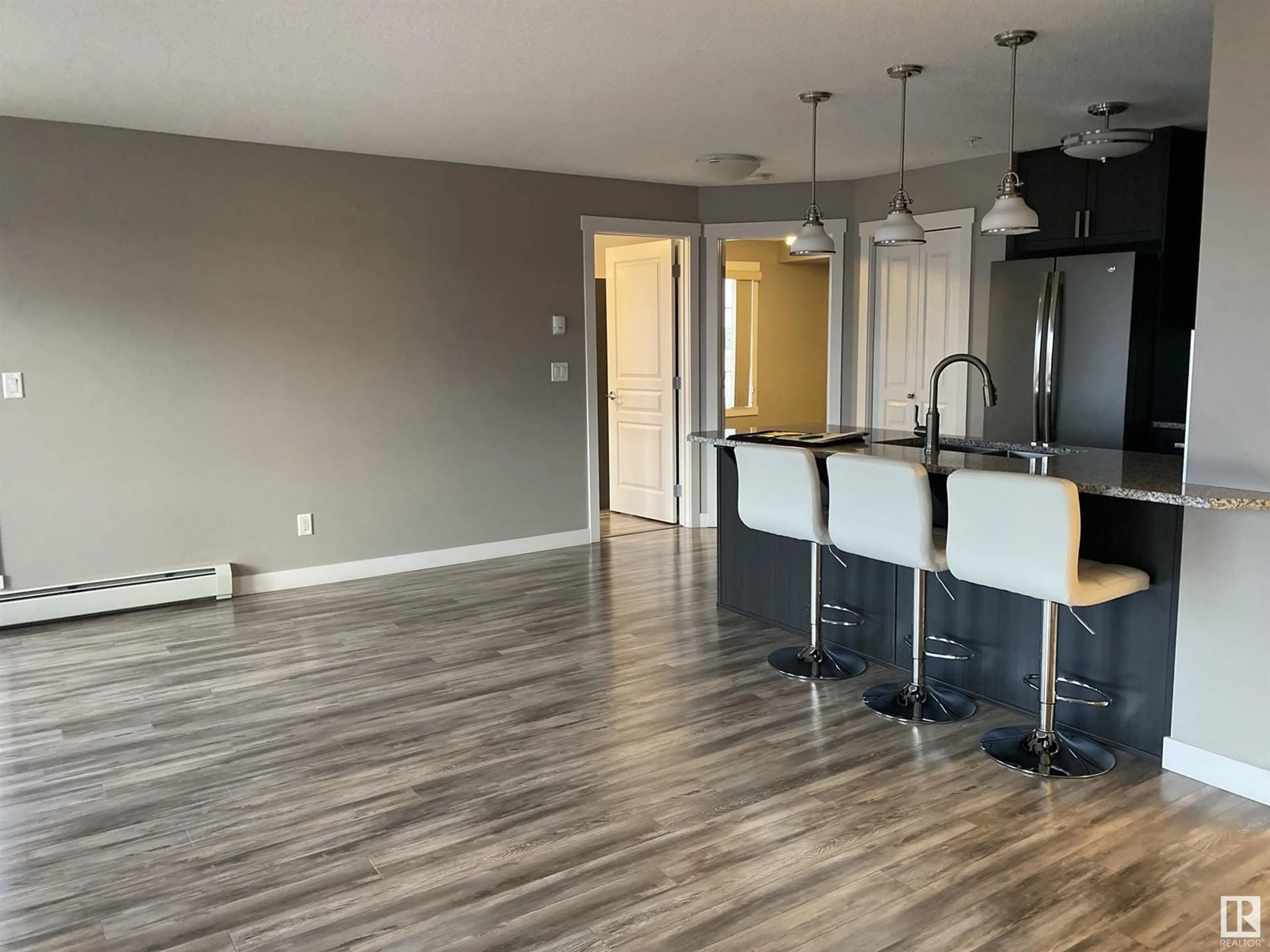 Open concept kitchen for #319 3670 139 AV NW NW, Edmonton Alberta T5Y3N5