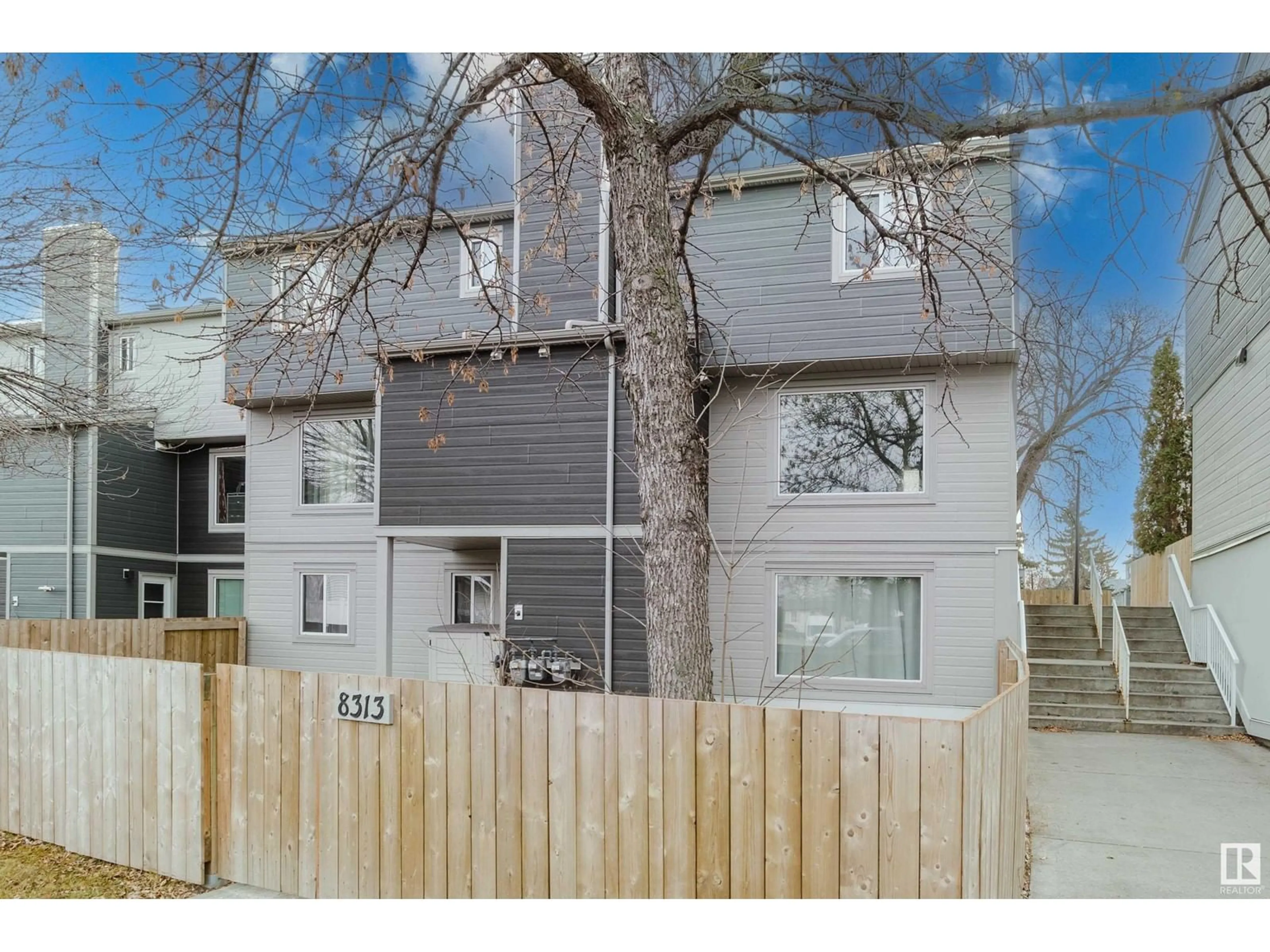 A pic from exterior of the house or condo, the fenced backyard for 8313 29 AV NW, Edmonton Alberta T6K3J9