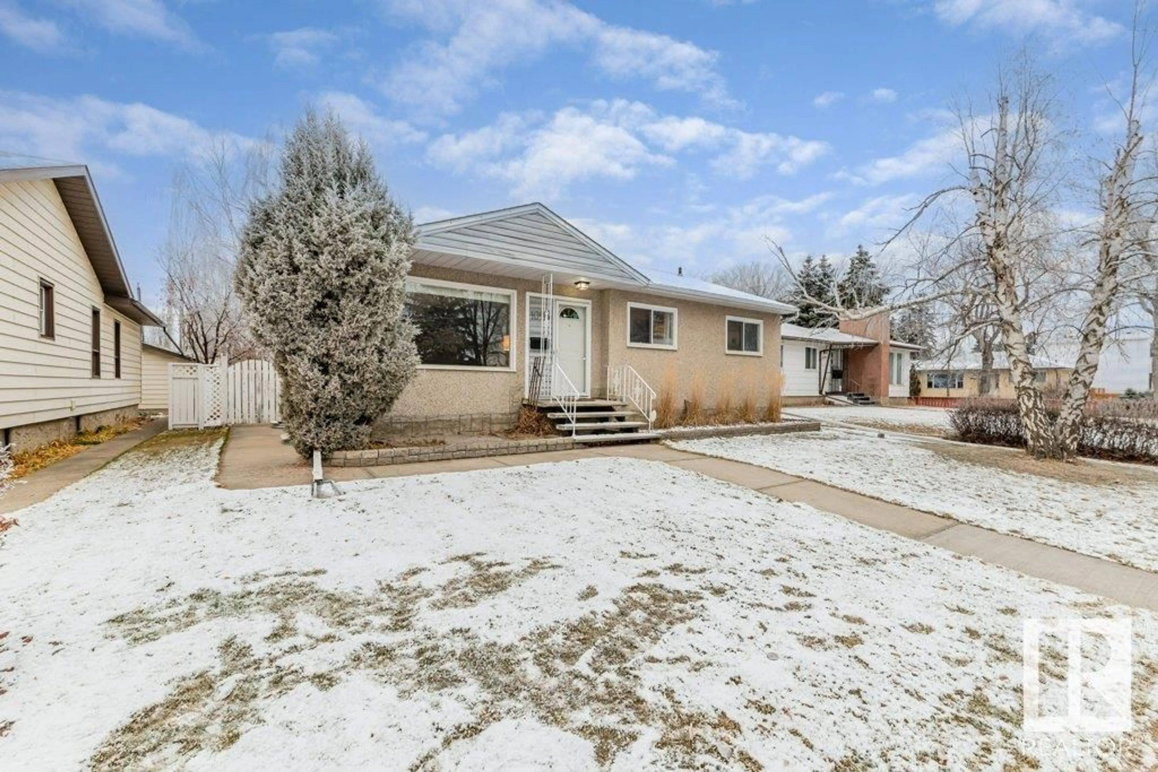 Frontside or backside of a home, the fenced backyard for 10916 139 ST NW, Edmonton Alberta T5M1P9