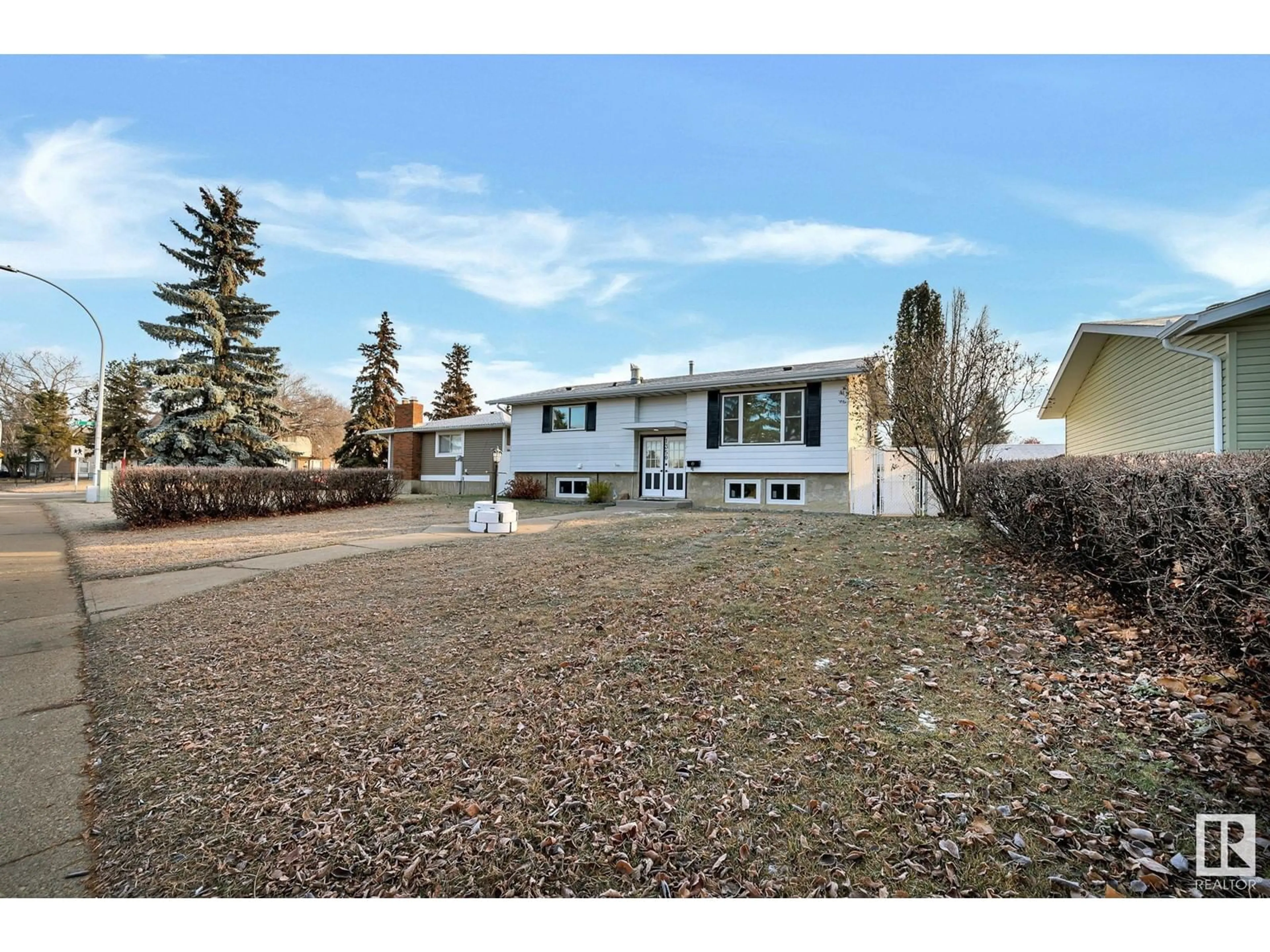 Frontside or backside of a home, the fenced backyard for 1350 Knottwood Rd E NW, Edmonton Alberta T6K2J8