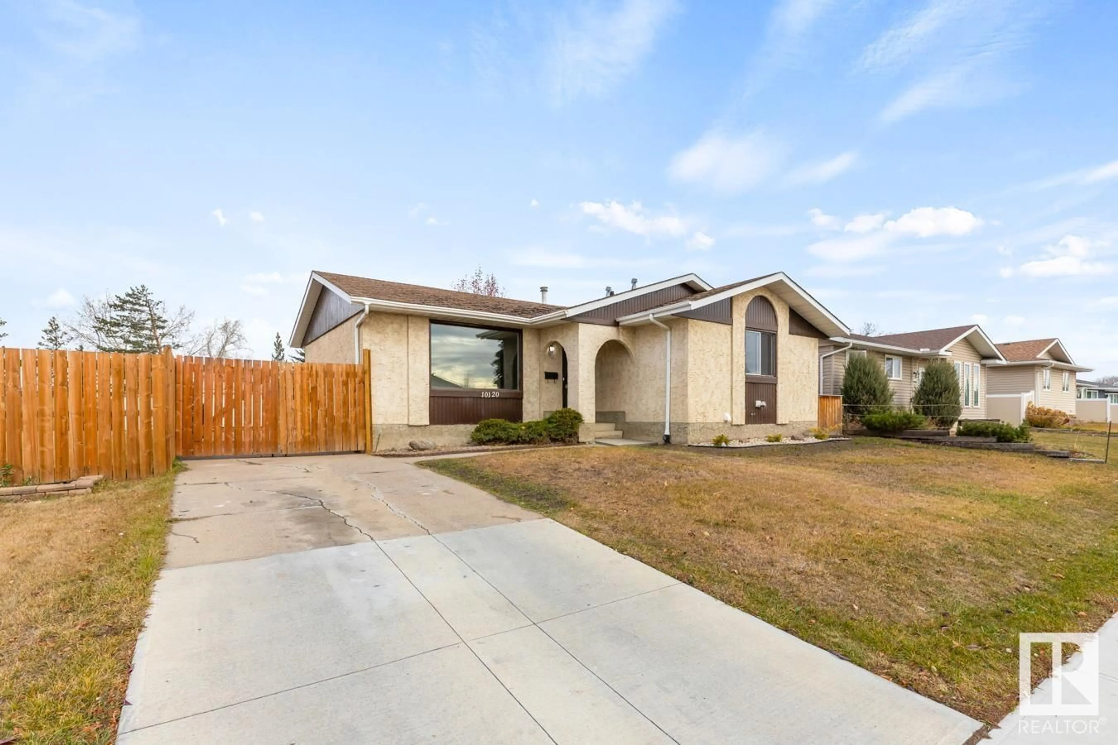 Frontside or backside of a home, the fenced backyard for 10120 166 AV NW, Edmonton Alberta T5X2G5