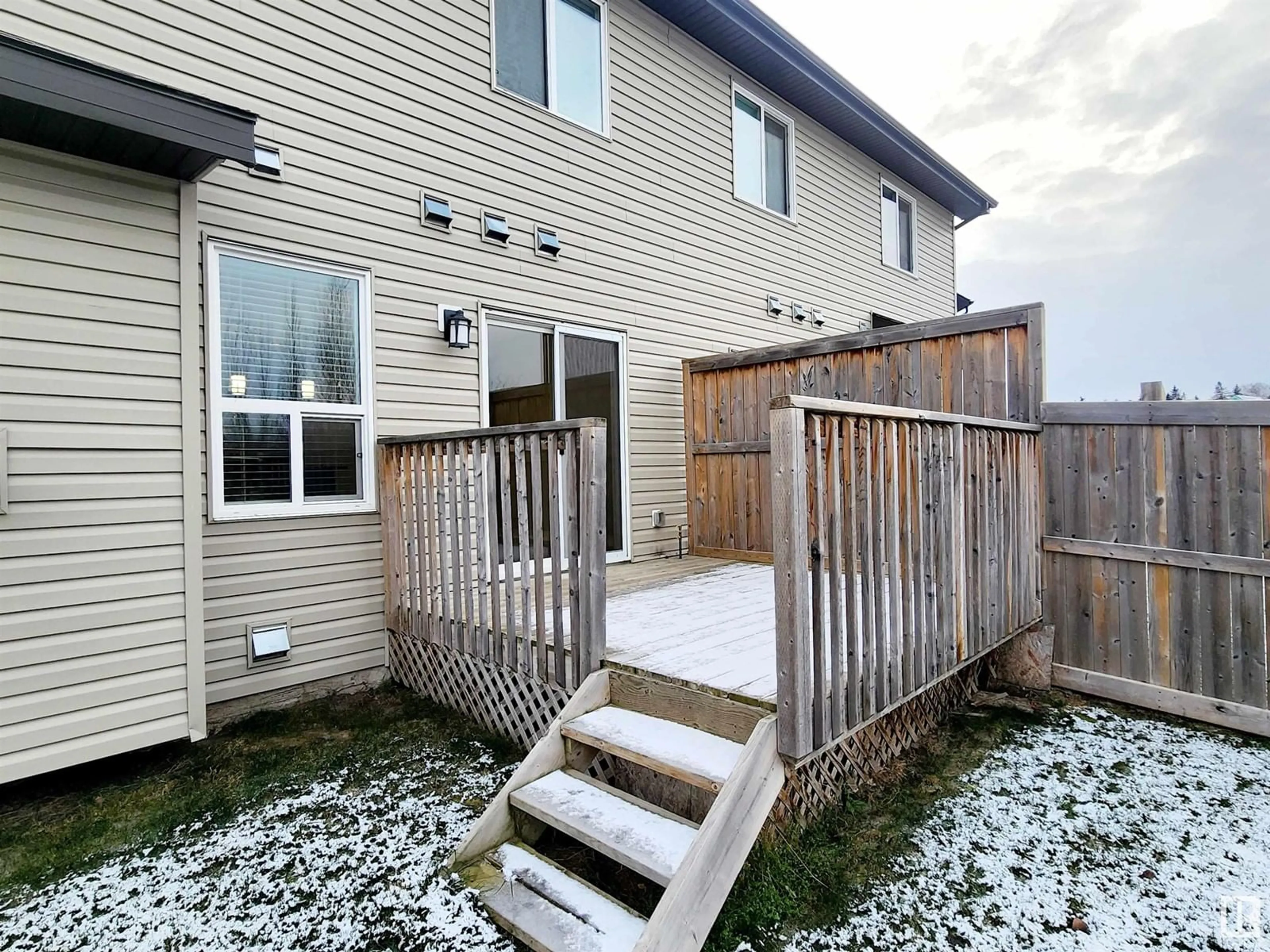 A pic from exterior of the house or condo, the fenced backyard for 20316 43 AV NW, Edmonton Alberta T6M0R8