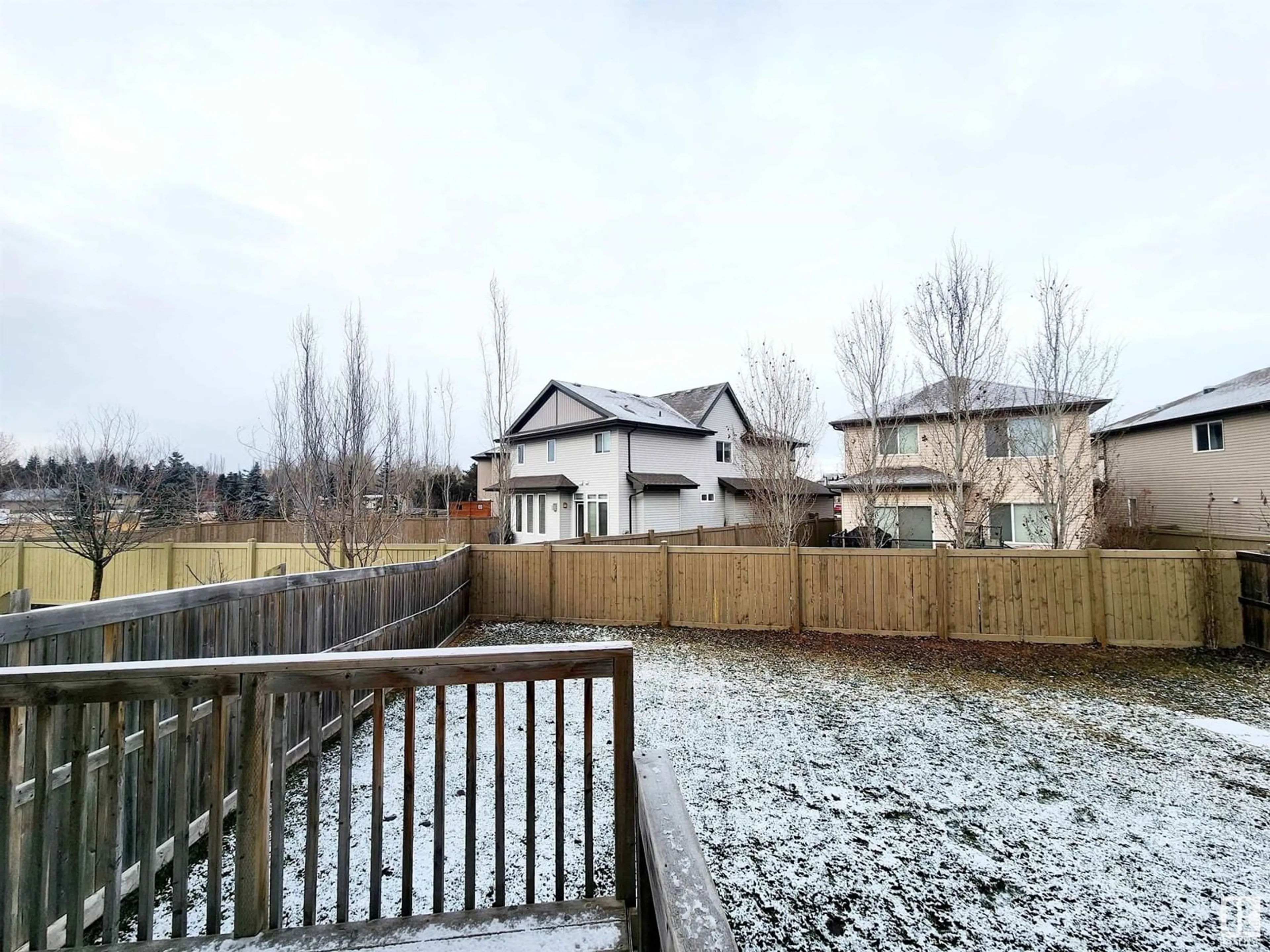 Frontside or backside of a home, the fenced backyard for 20316 43 AV NW, Edmonton Alberta T6M0R8