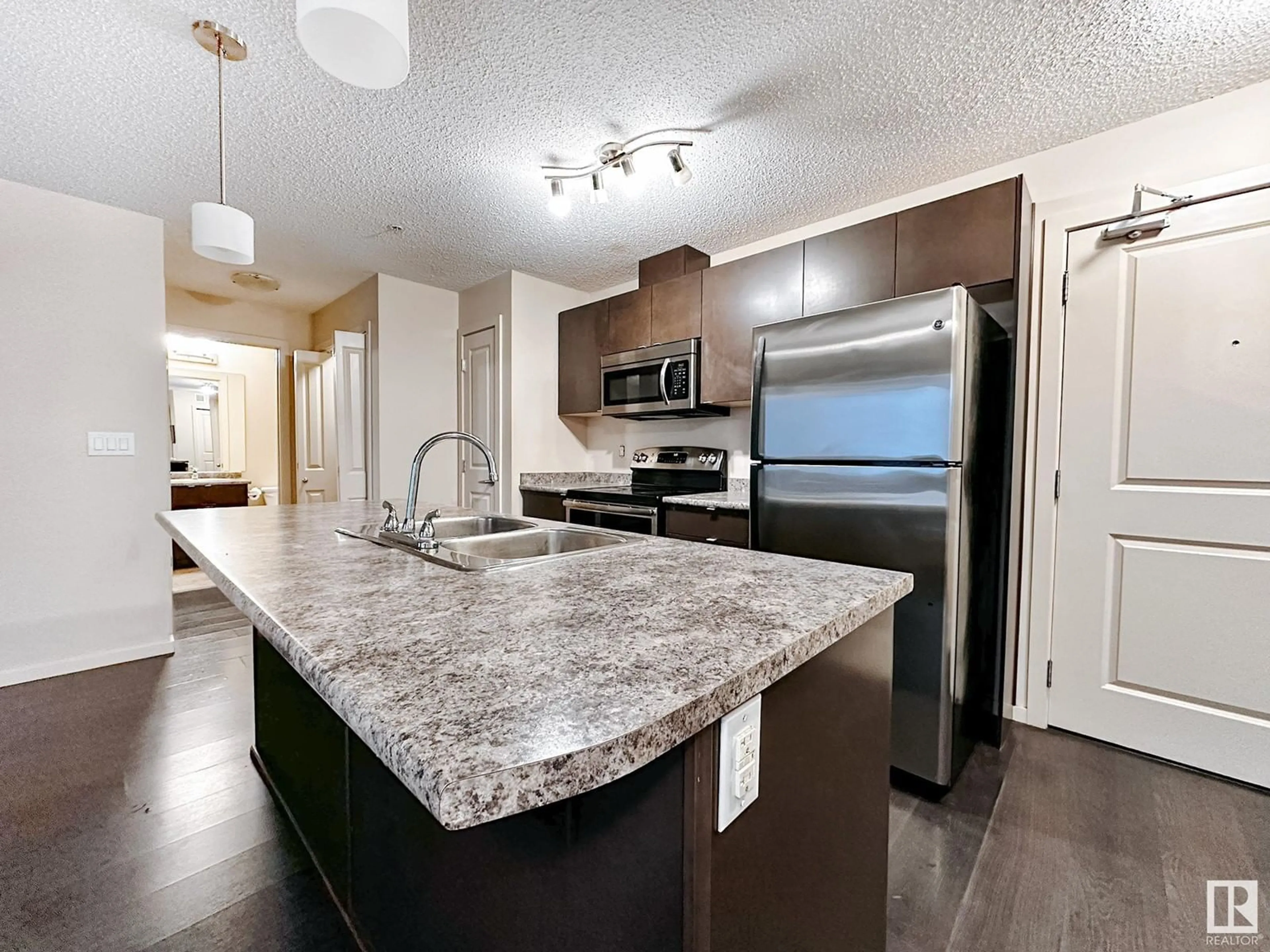 Open concept kitchen for #317 3357 16A AV NW, Edmonton Alberta T6T0V4