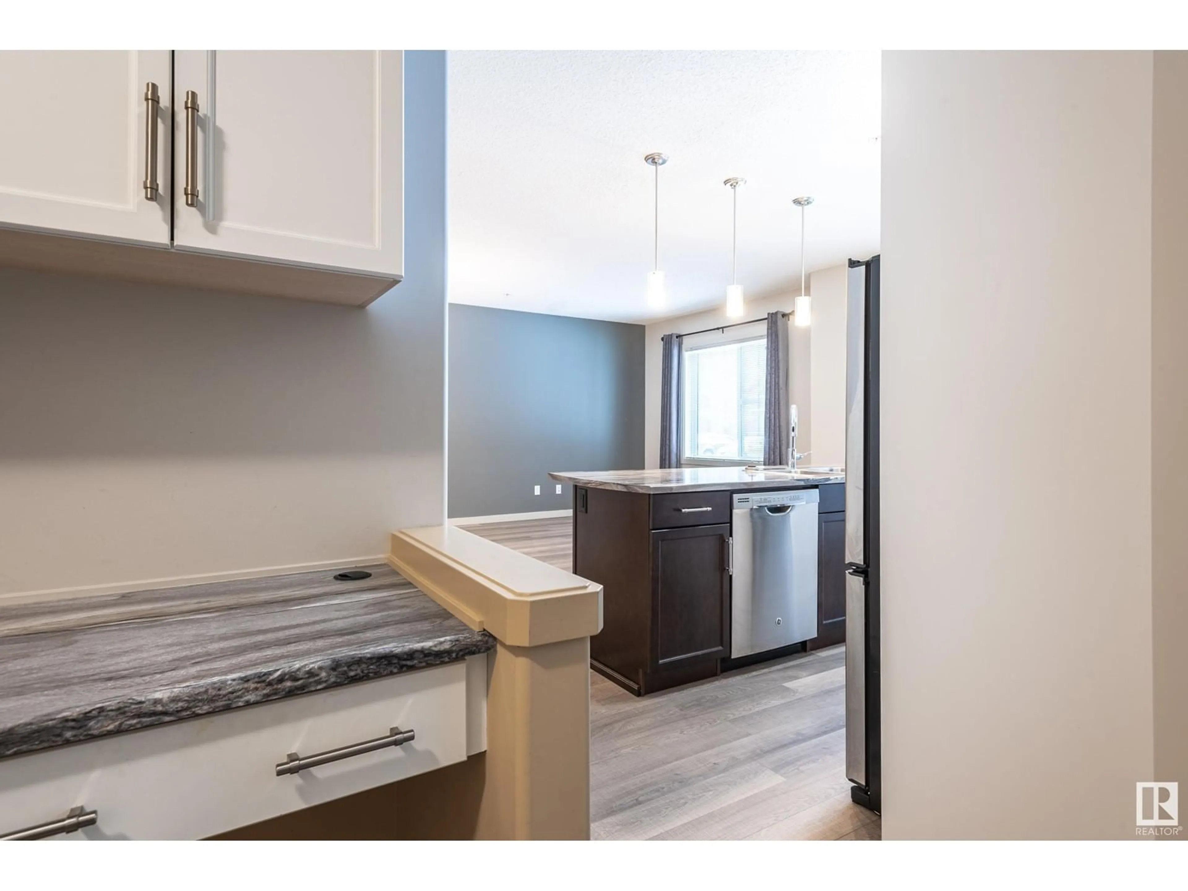 Open concept kitchen for #113 320 AMBLESIDE LI SW, Edmonton Alberta T6W2Z9