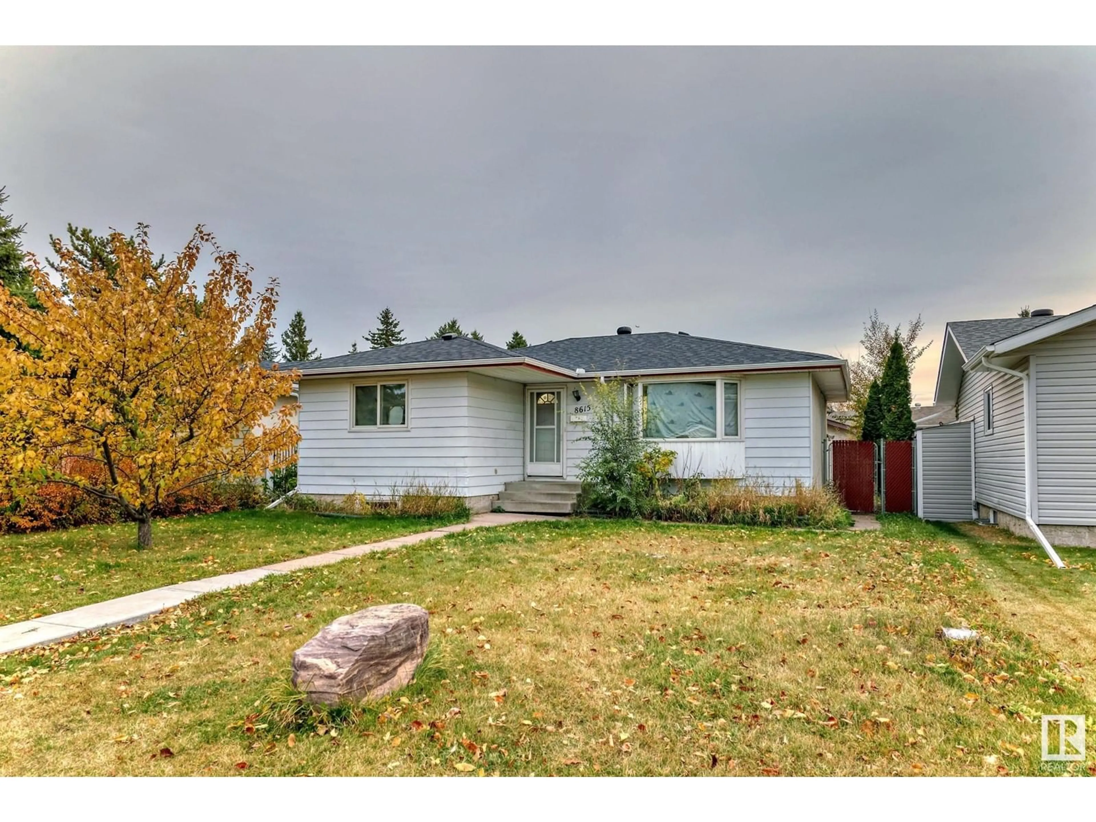 Frontside or backside of a home, the fenced backyard for 8615 42A AV NW, Edmonton Alberta T6K1E6