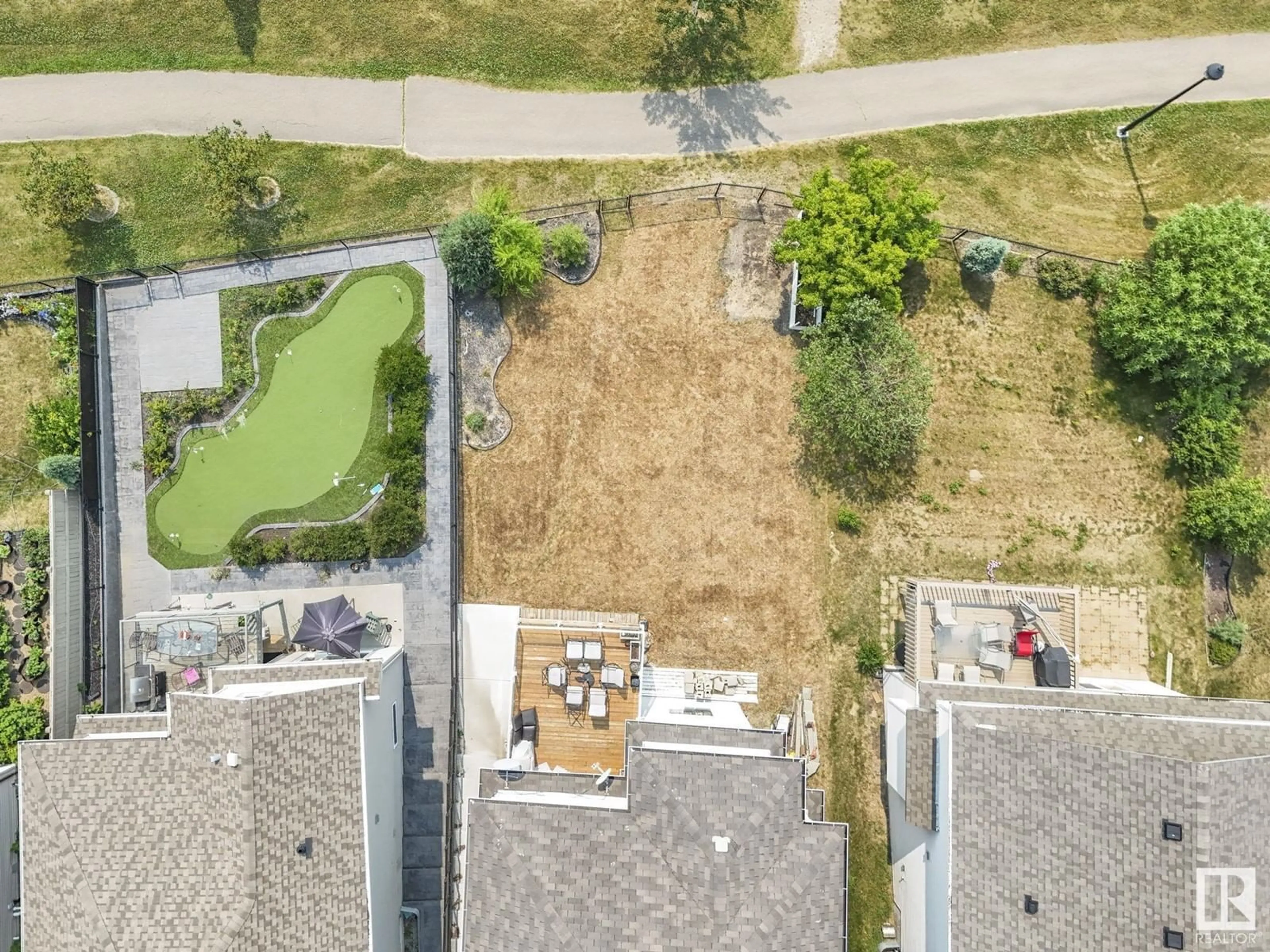 Frontside or backside of a home, the fenced backyard for 6303 4 AV SW SW, Edmonton Alberta T6X0C2