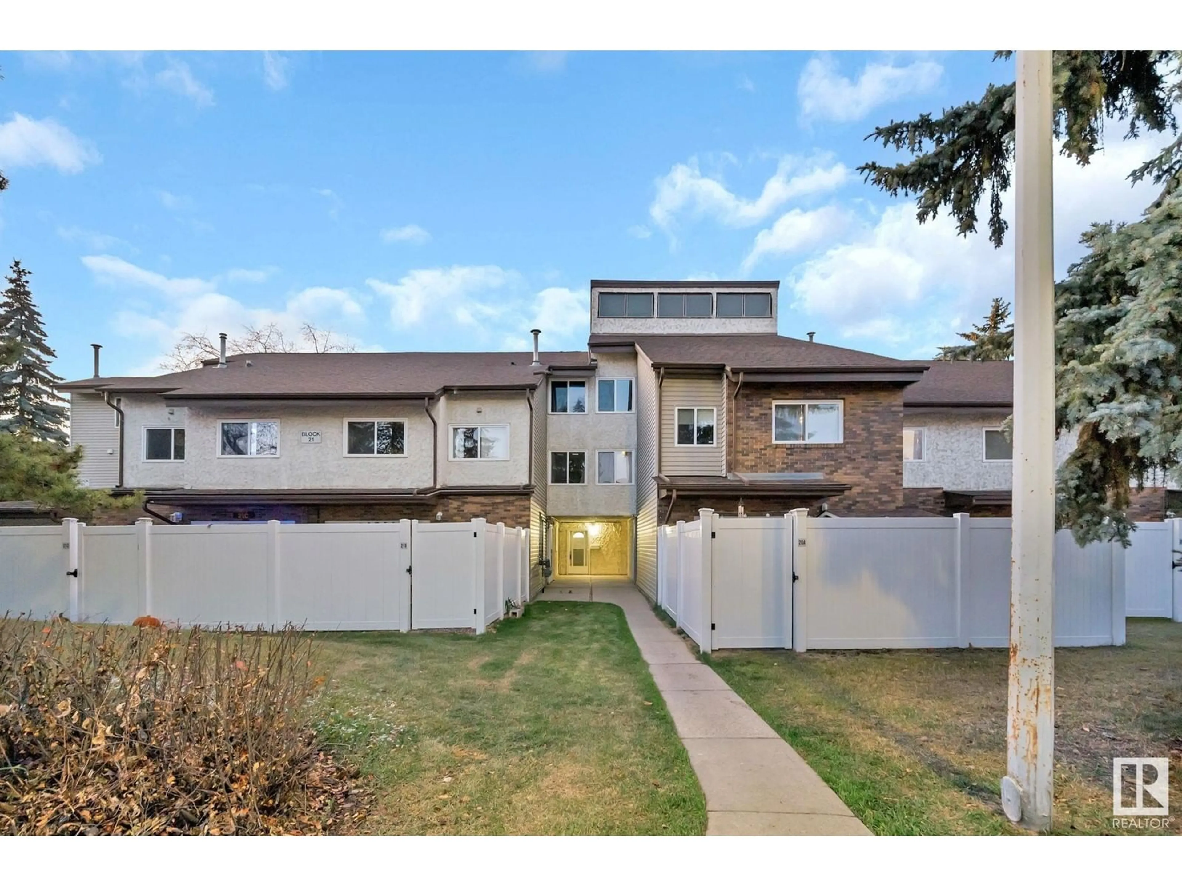 A pic from exterior of the house or condo, the fenced backyard for 21E MEADOWLARK VG NW, Edmonton Alberta T5R5X3