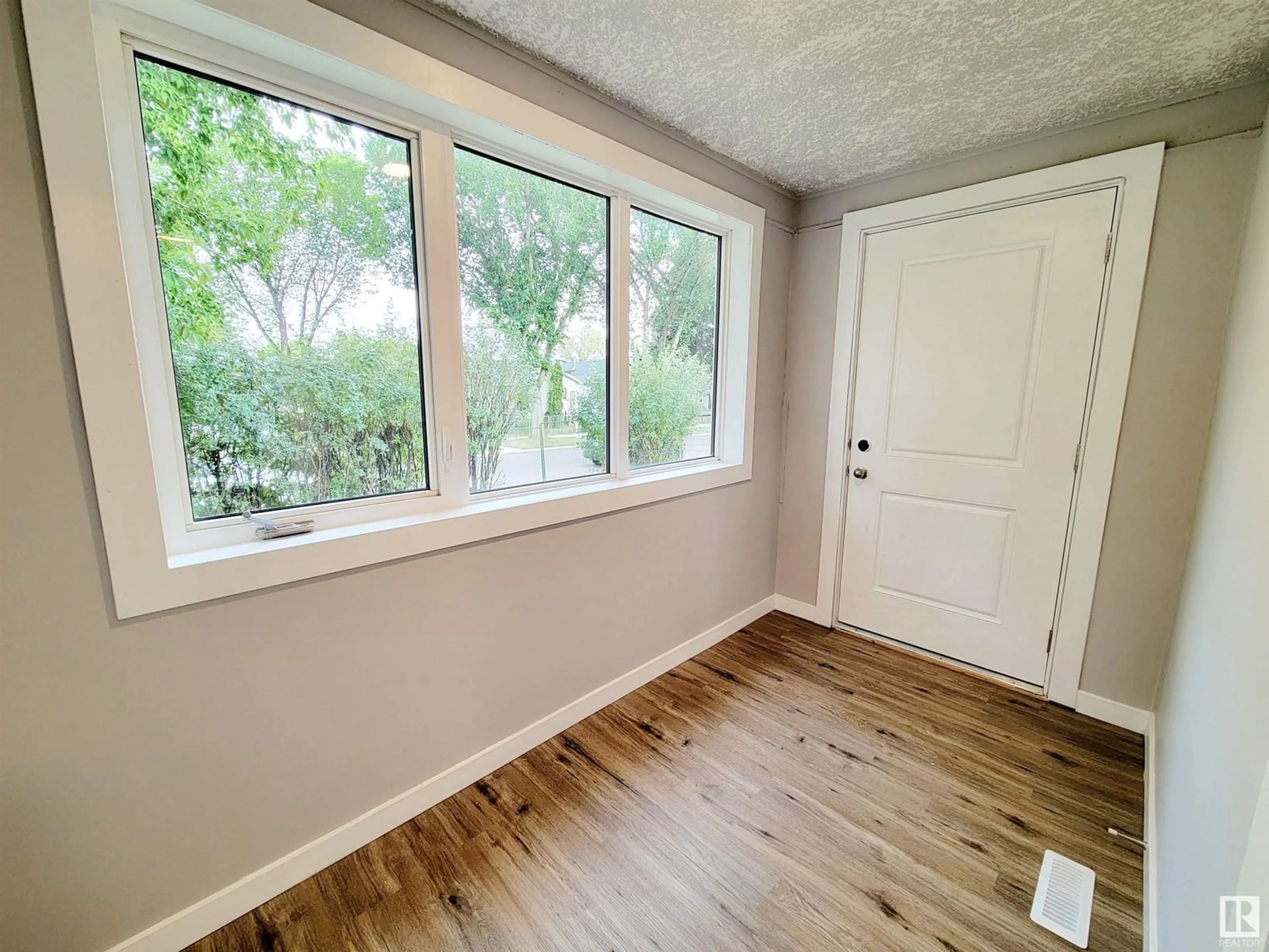 A pic of a room, wood floors for 12018 77 ST NW NW, Edmonton Alberta T5B2G7