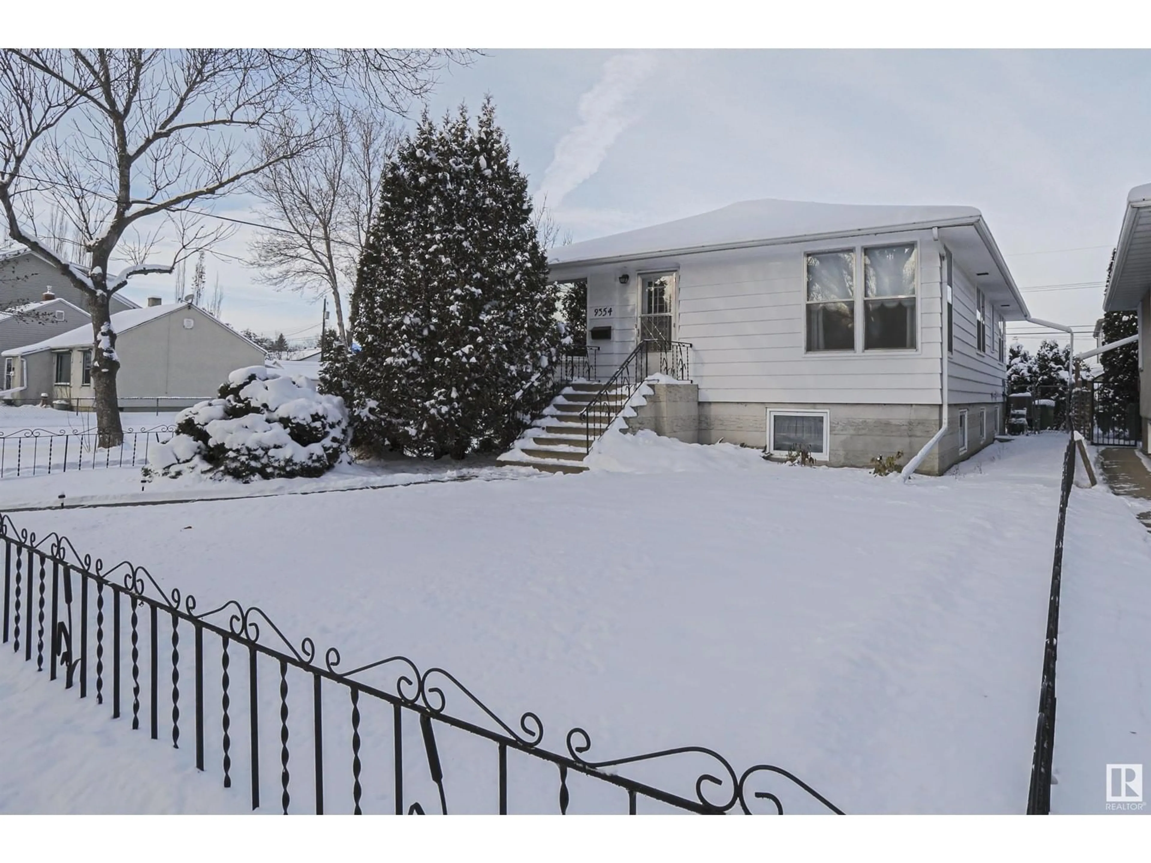 Frontside or backside of a home, the fenced backyard for 9354 72 AV NW, Edmonton Alberta T6E0Y2