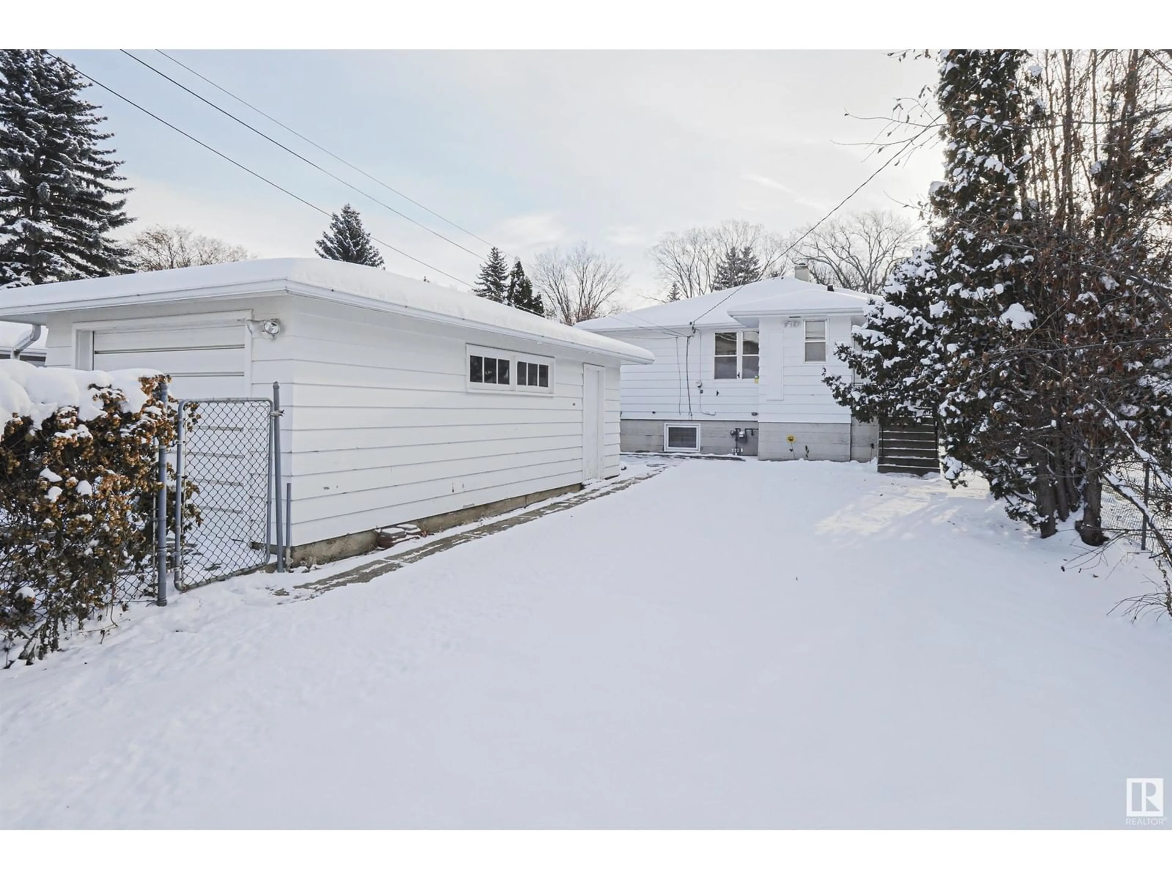 Frontside or backside of a home, the fenced backyard for 9354 72 AV NW, Edmonton Alberta T6E0Y2