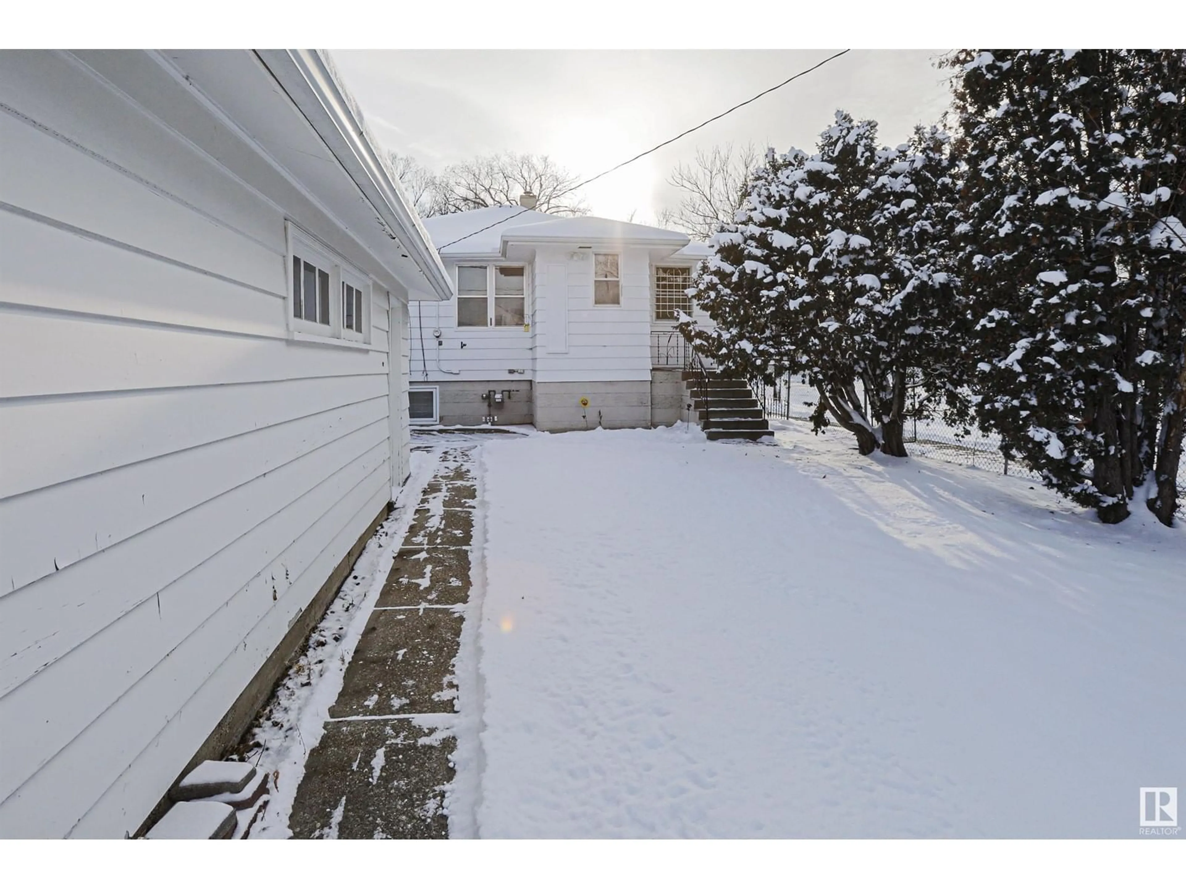 Frontside or backside of a home, the fenced backyard for 9354 72 AV NW, Edmonton Alberta T6E0Y2