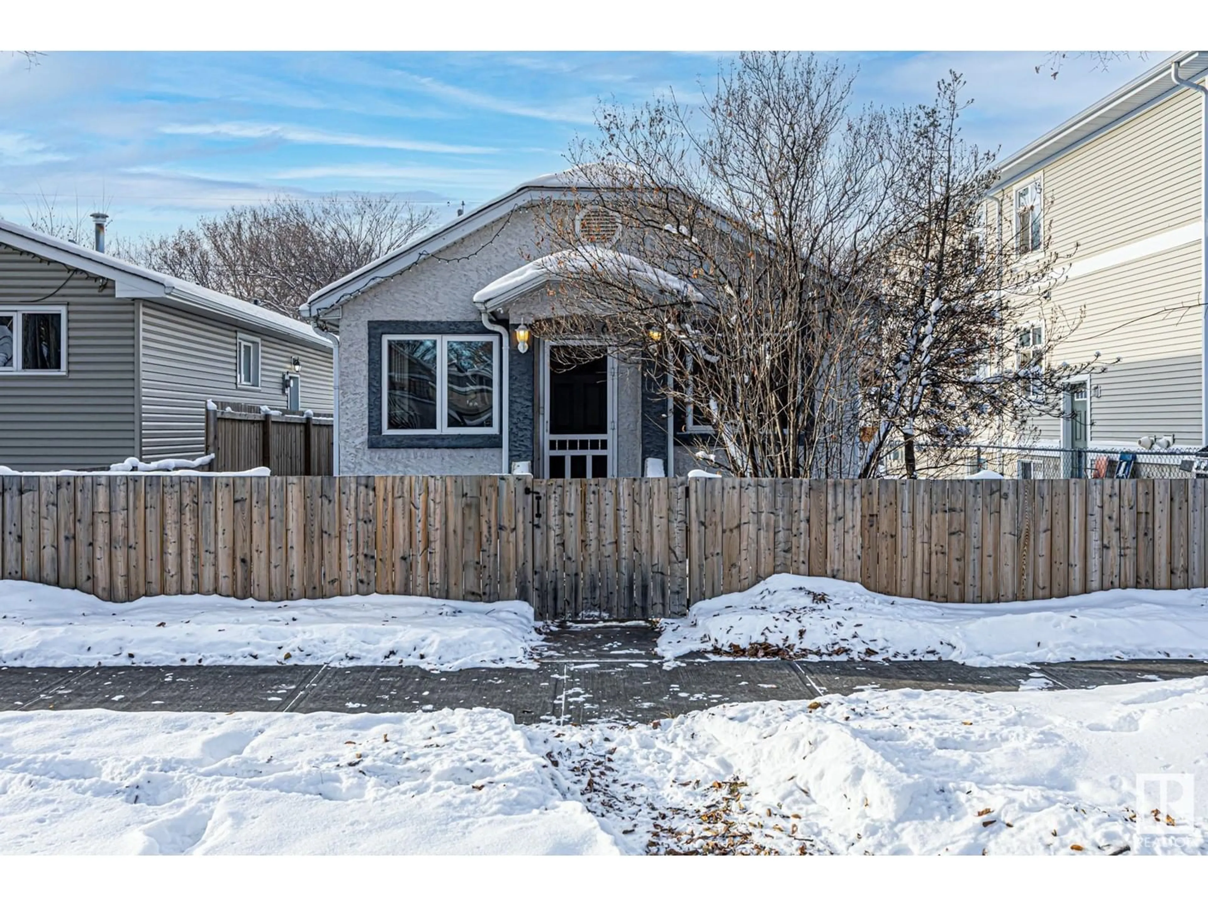 A pic from exterior of the house or condo, the fenced backyard for 12034 62 ST NW, Edmonton Alberta T5W4C8