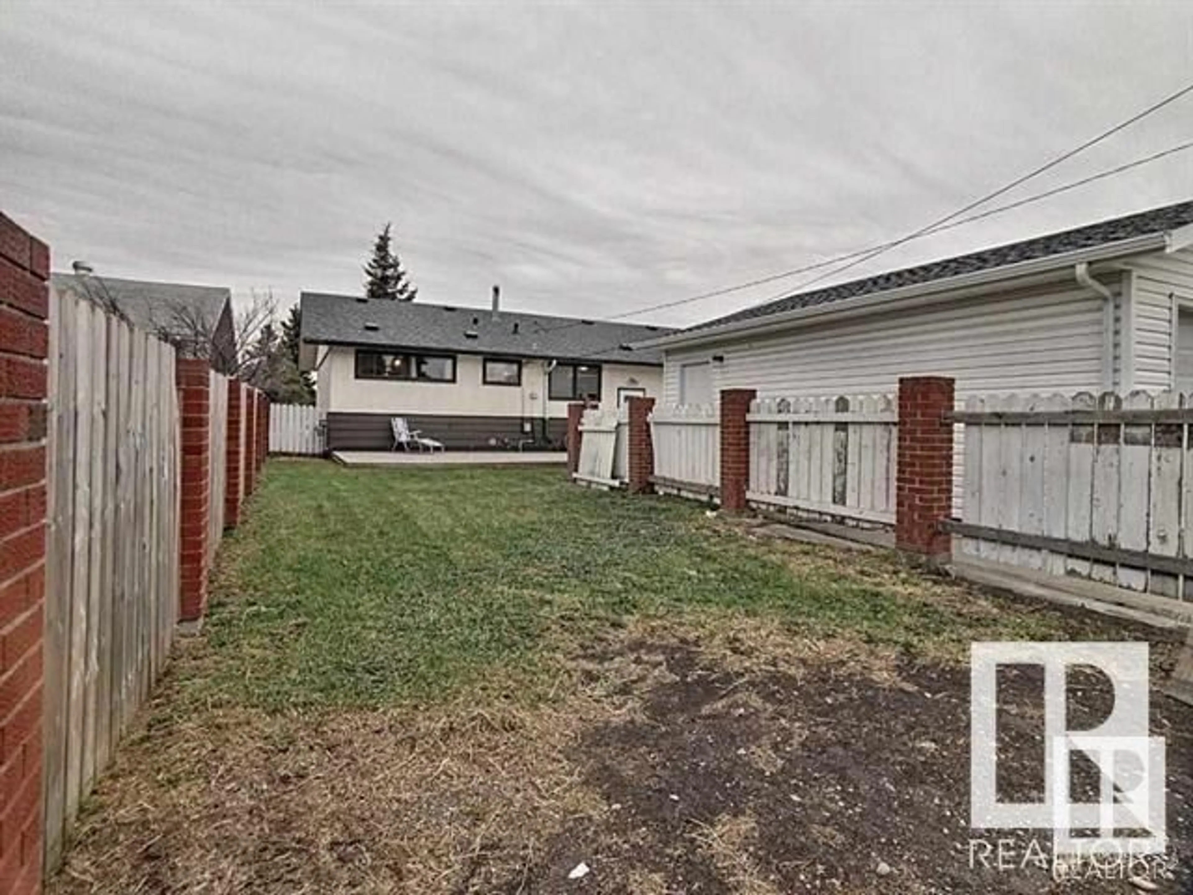 Frontside or backside of a home, the fenced backyard for 16322 87 AV NW, Edmonton Alberta T5R4H2