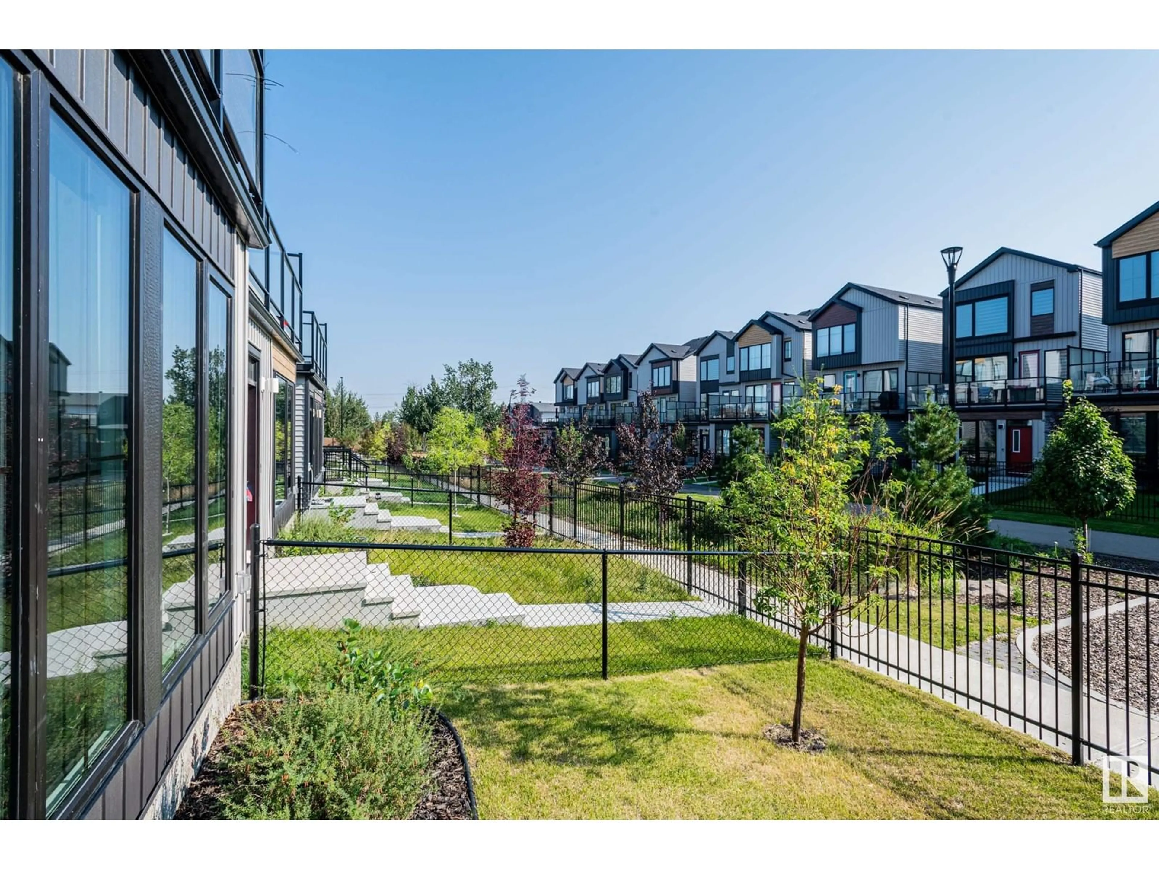 A pic from exterior of the house or condo, the fenced backyard for 439 39 ST SW, Edmonton Alberta T6X2X9