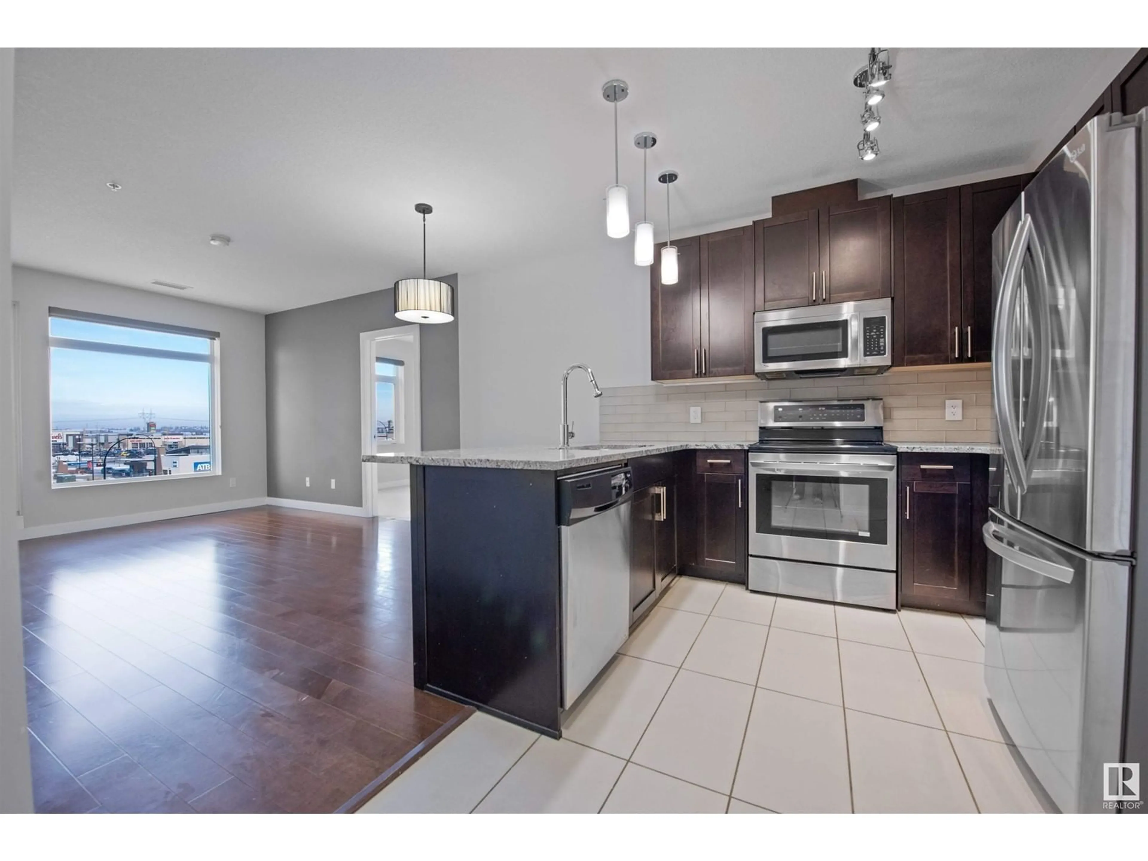 Open concept kitchen for #410 5151 Windermere BV SW, Edmonton Alberta T6W2K4