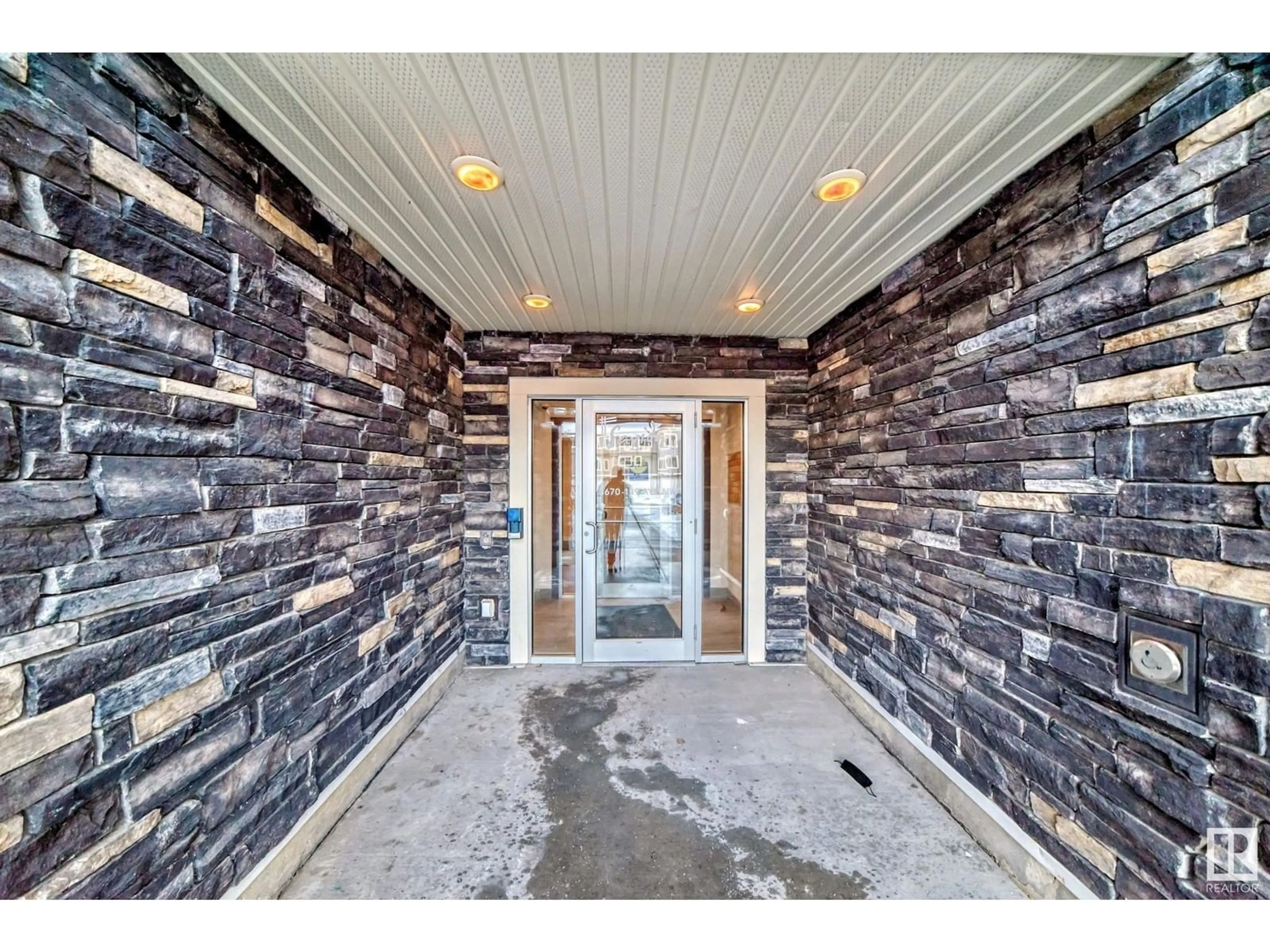 Indoor entryway, cement floor for #205 3670 139 AV NW, Edmonton Alberta T5Y3N5