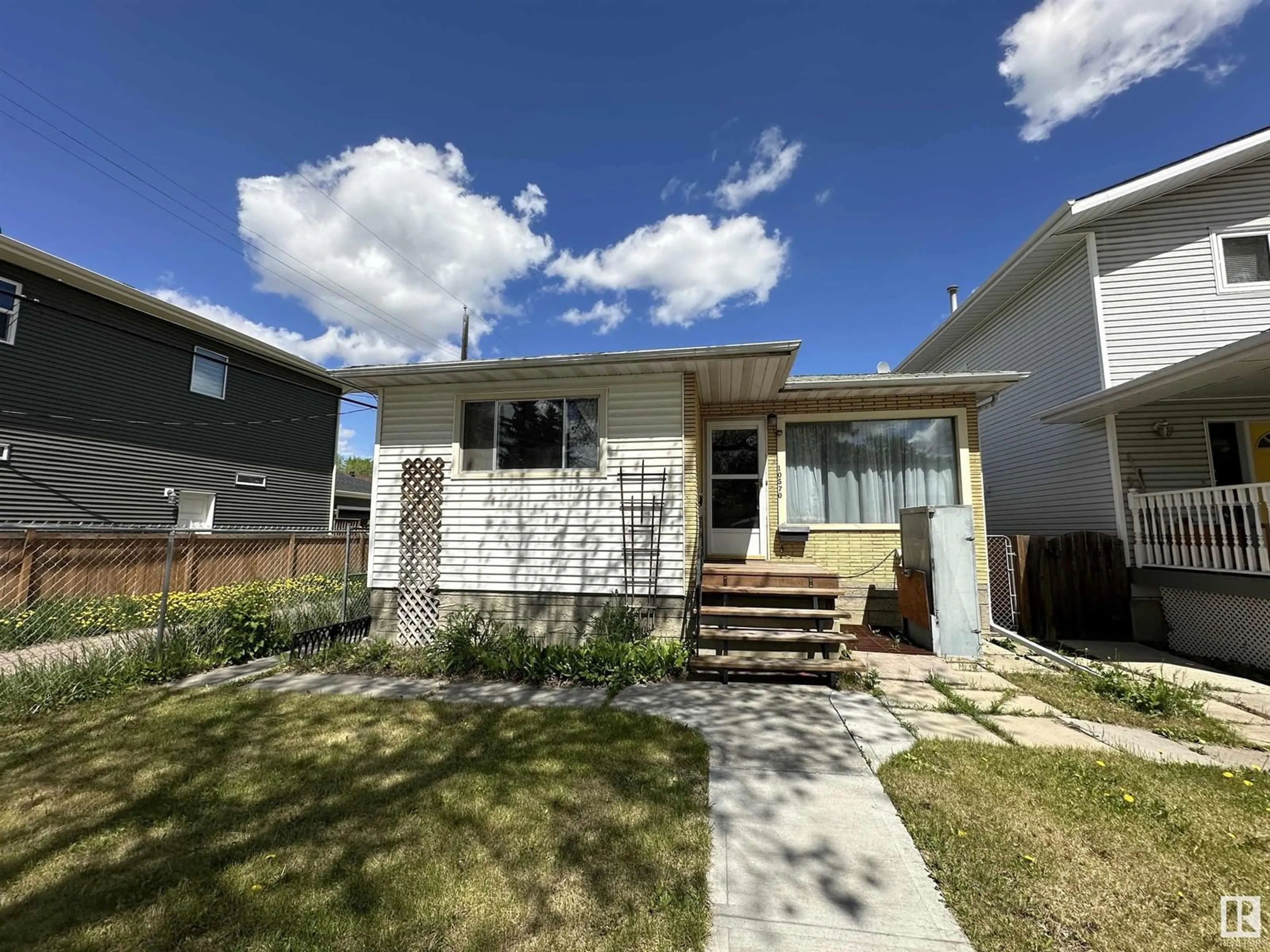 Frontside or backside of a home, the fenced backyard for 10570 62 AV NW, Edmonton Alberta T6H1M4