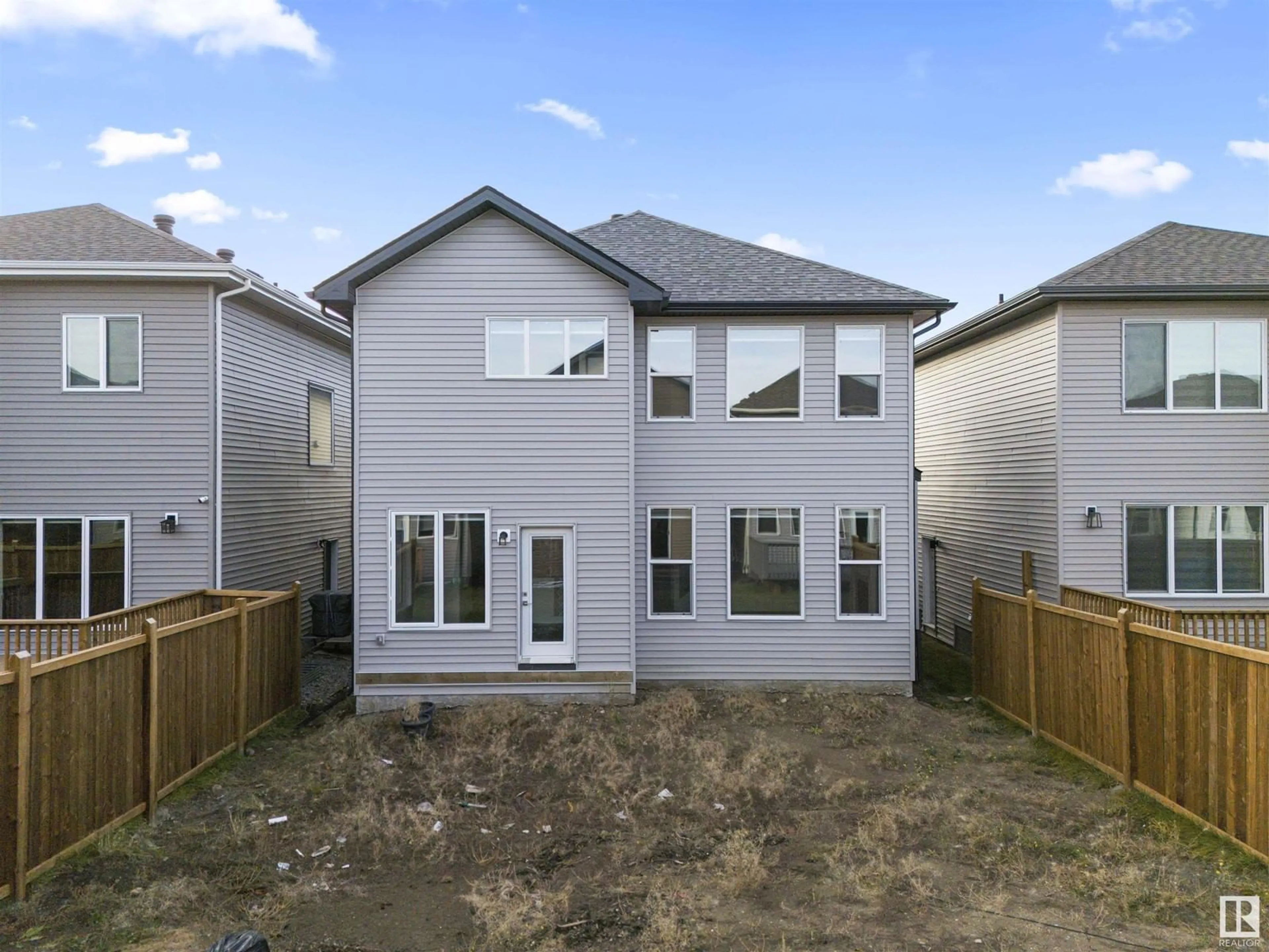 Frontside or backside of a home, the fenced backyard for 1635 16 st NW, Edmonton Alberta T6X2J2