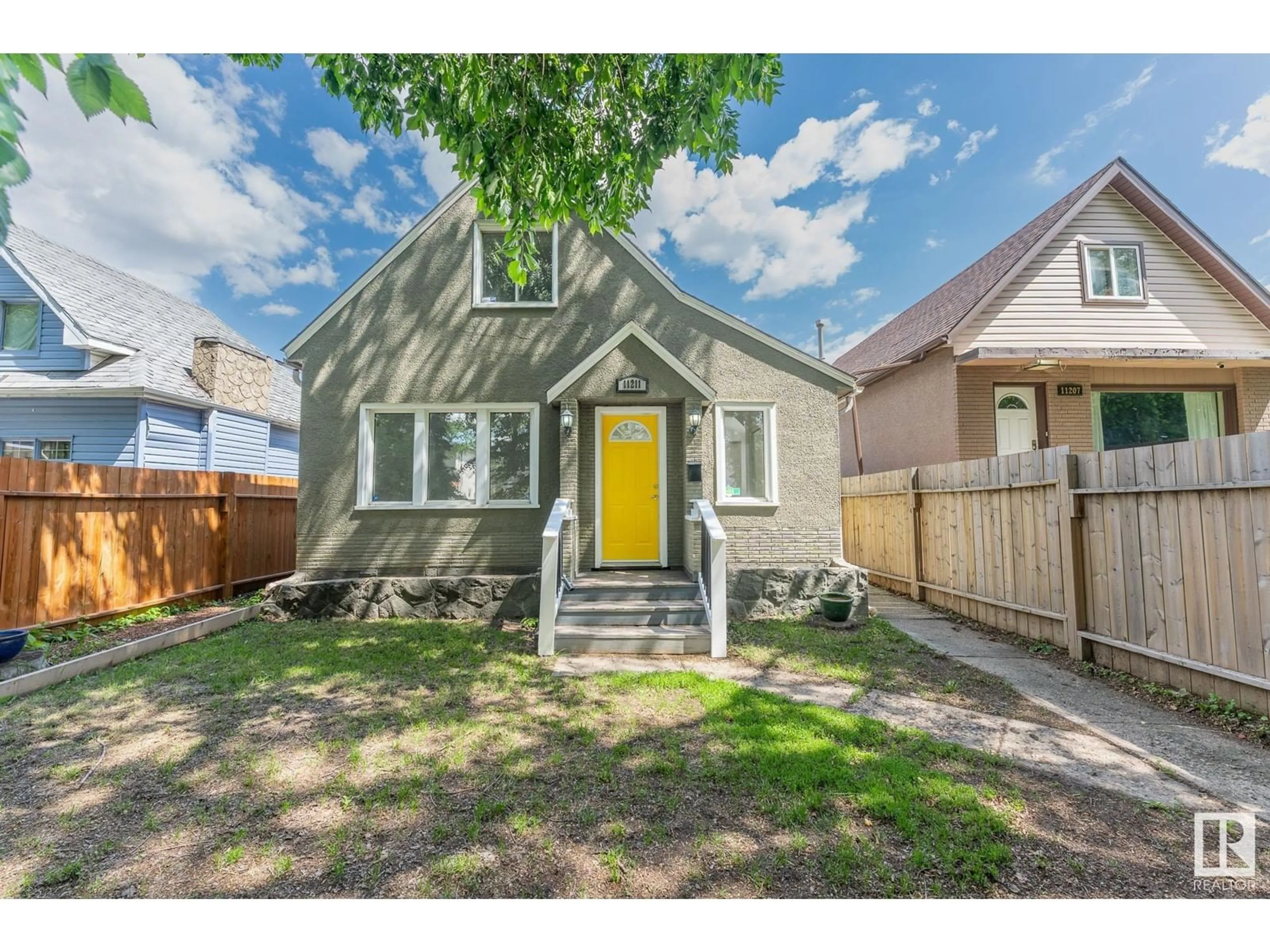 Frontside or backside of a home, the fenced backyard for 11211 93 ST NW, Edmonton Alberta T5G1B9