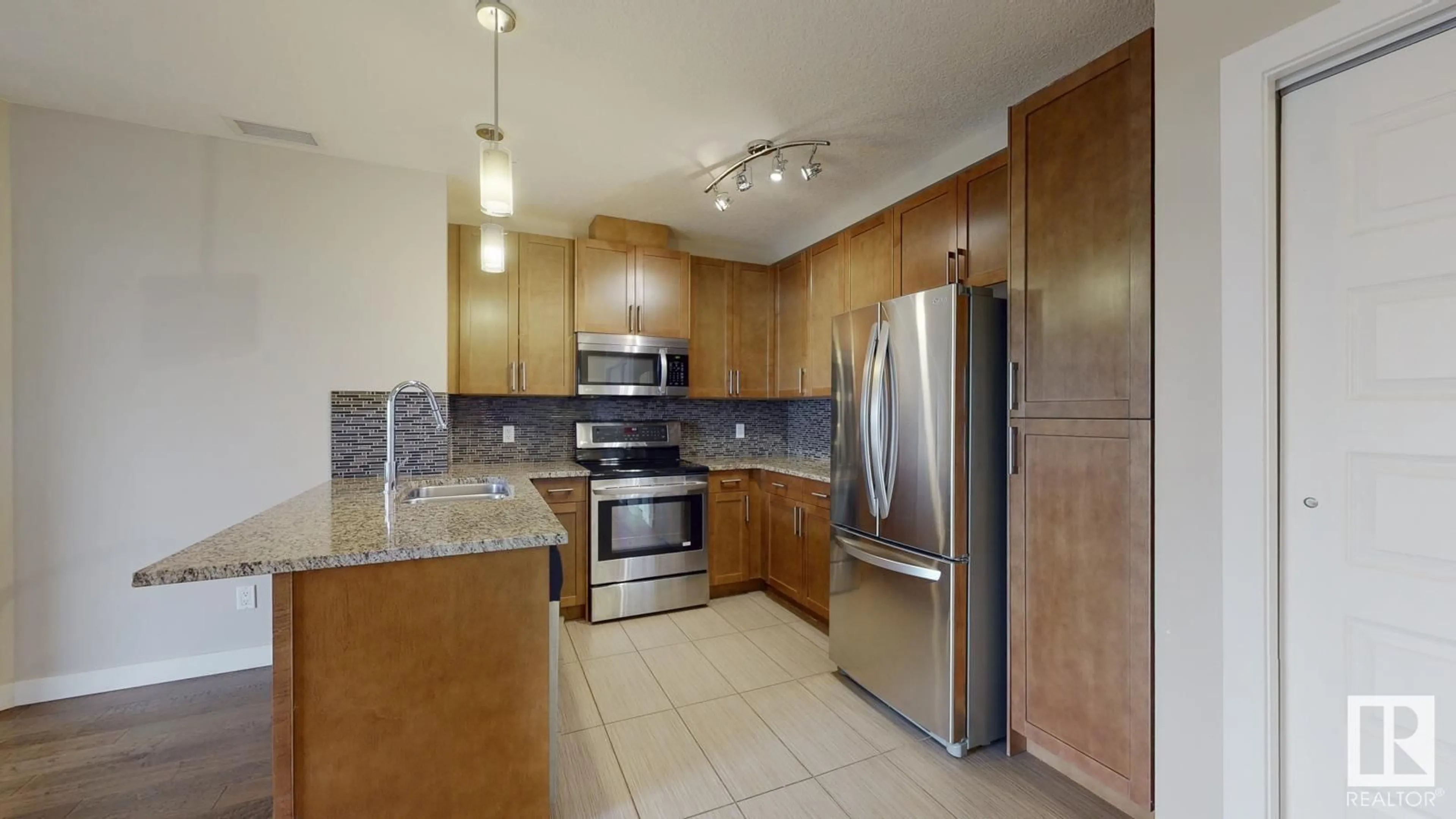 Kitchen, wood floors for #405 5151 WINDERMERE BV SW SW, Edmonton Alberta T6W2K4