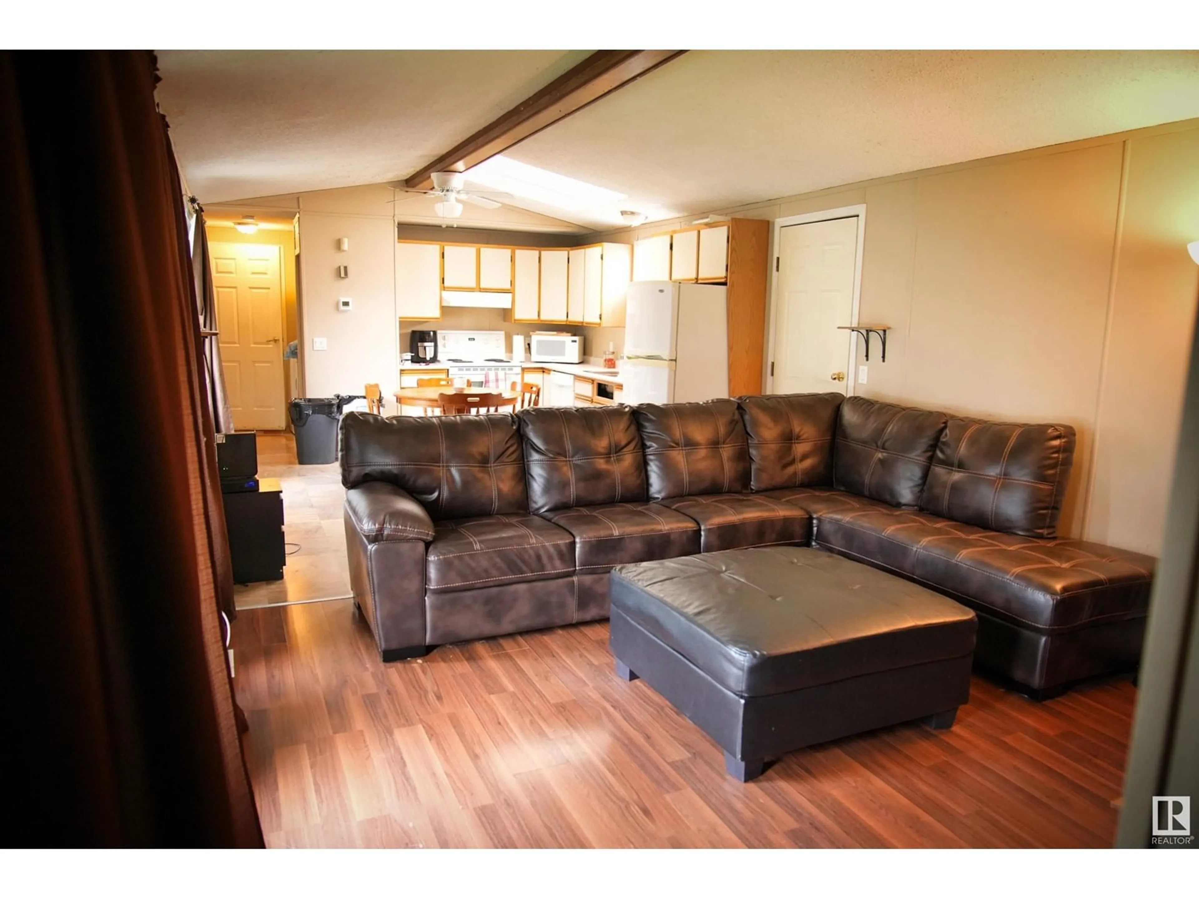 Living room with furniture, wood/laminate floor for #102 4819 51 Ave, Millet Alberta T0C1Z0