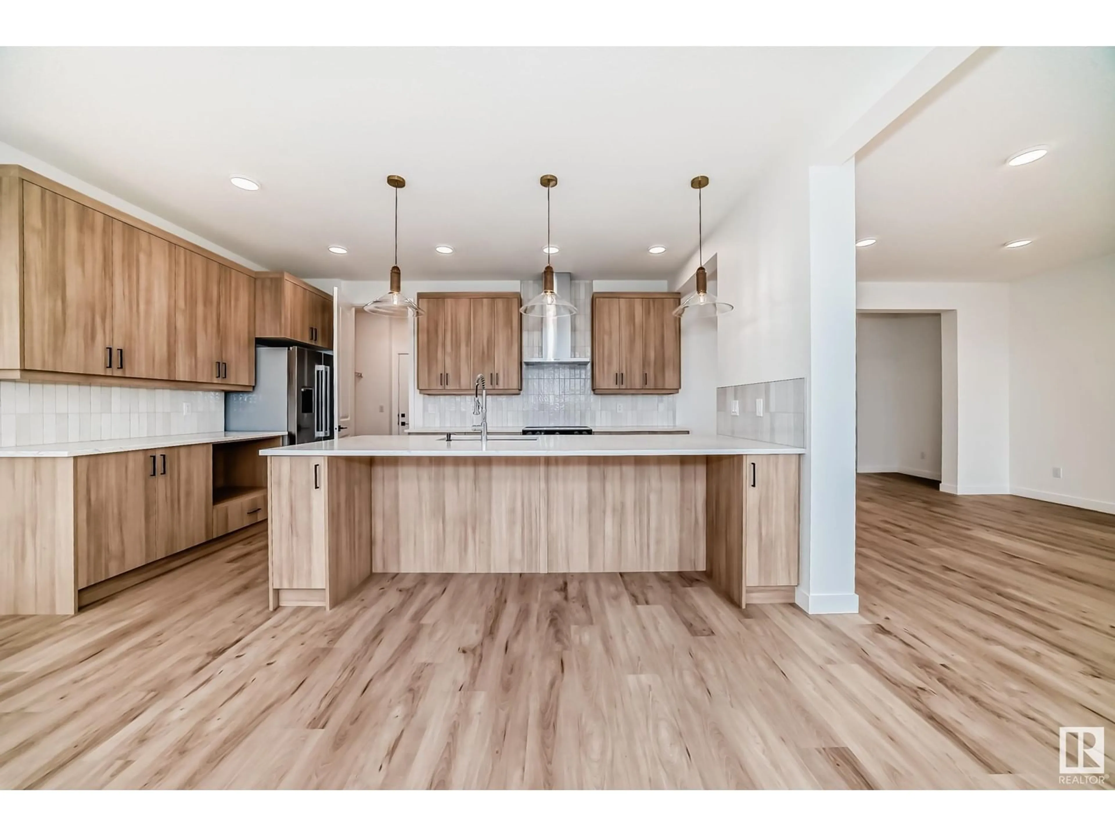 Open concept kitchen, wood/laminate floor for 5828 Kootook LI SW, Edmonton Alberta T6W4Z6