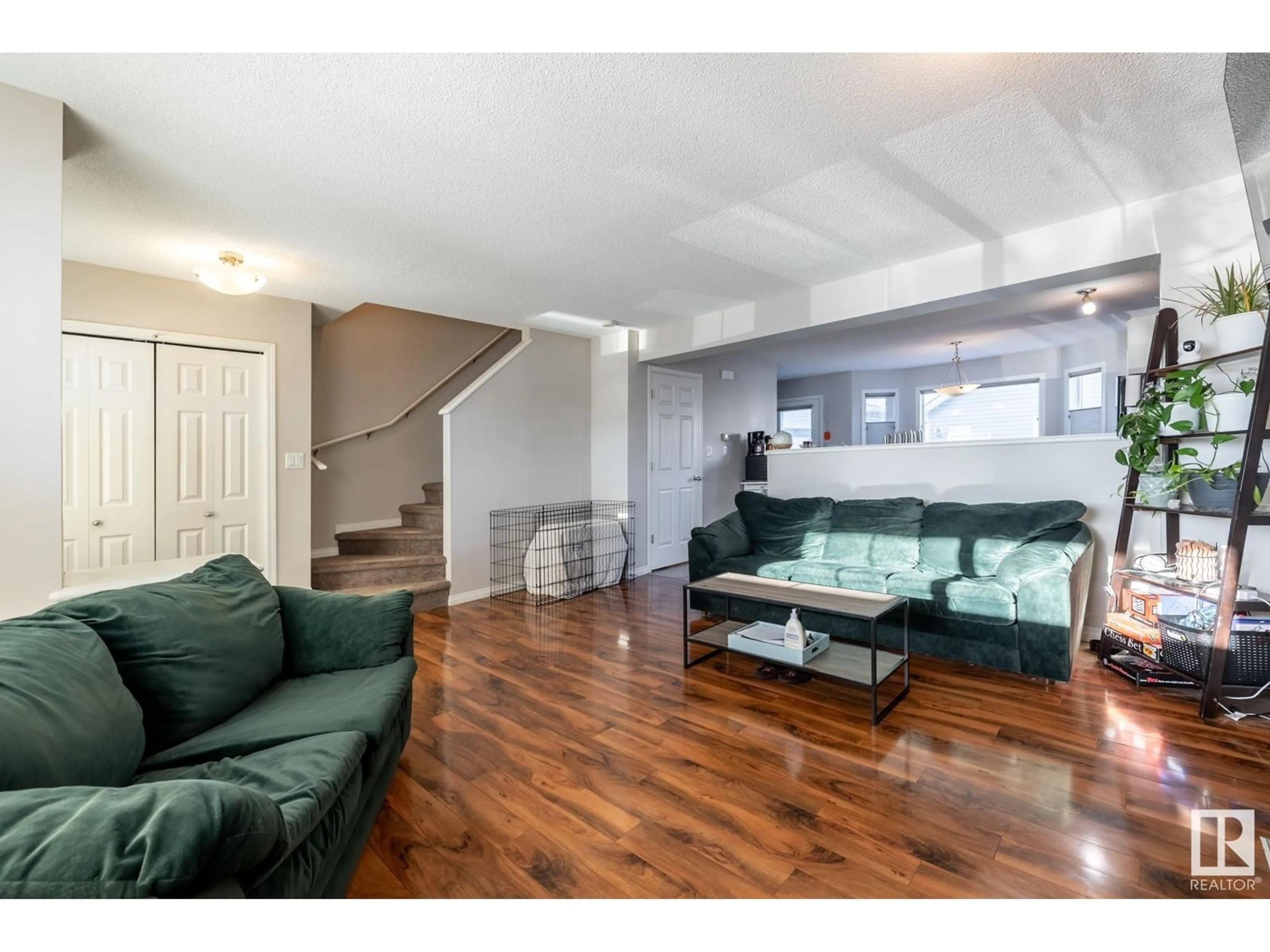 Living room with furniture, wood/laminate floor for 6822 21A AV SW, Edmonton Alberta T6X0S3