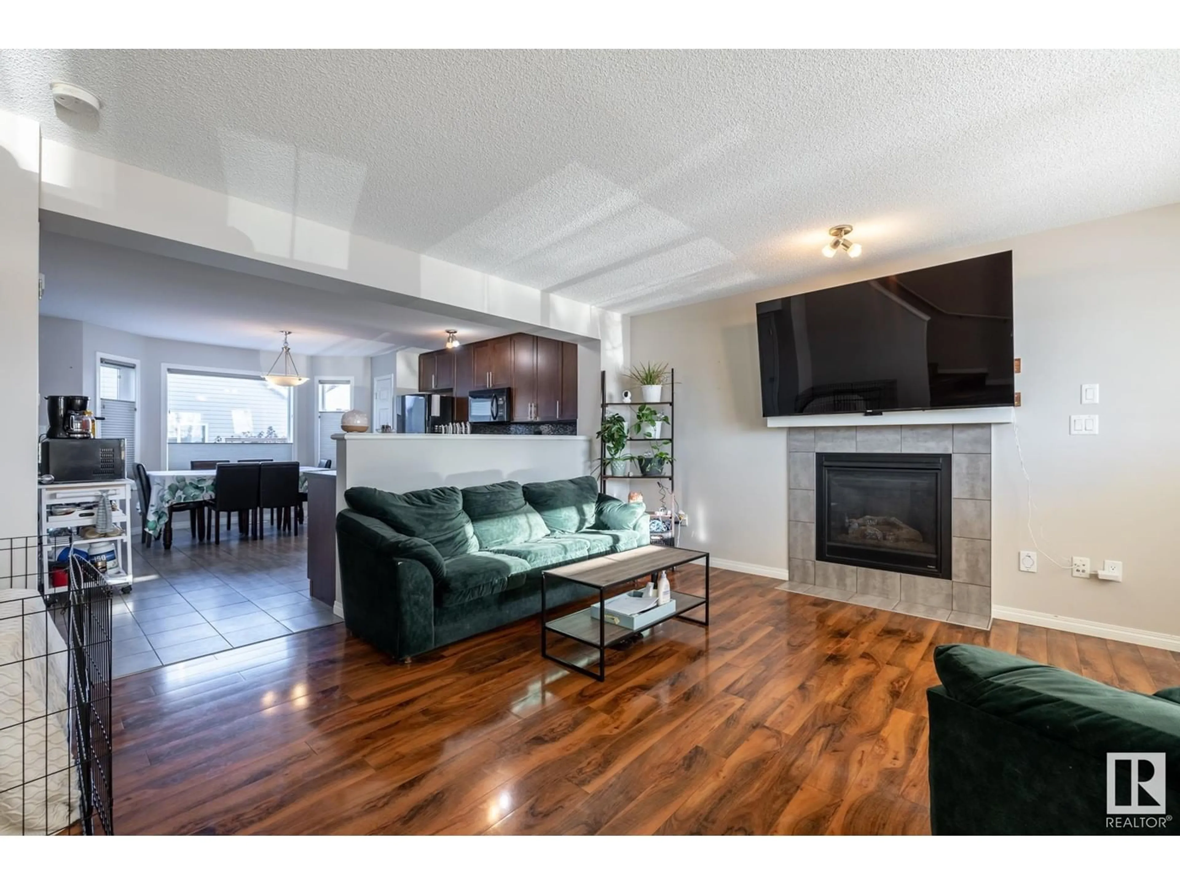 Living room with furniture, wood/laminate floor for 6822 21A AV SW, Edmonton Alberta T6X0S3