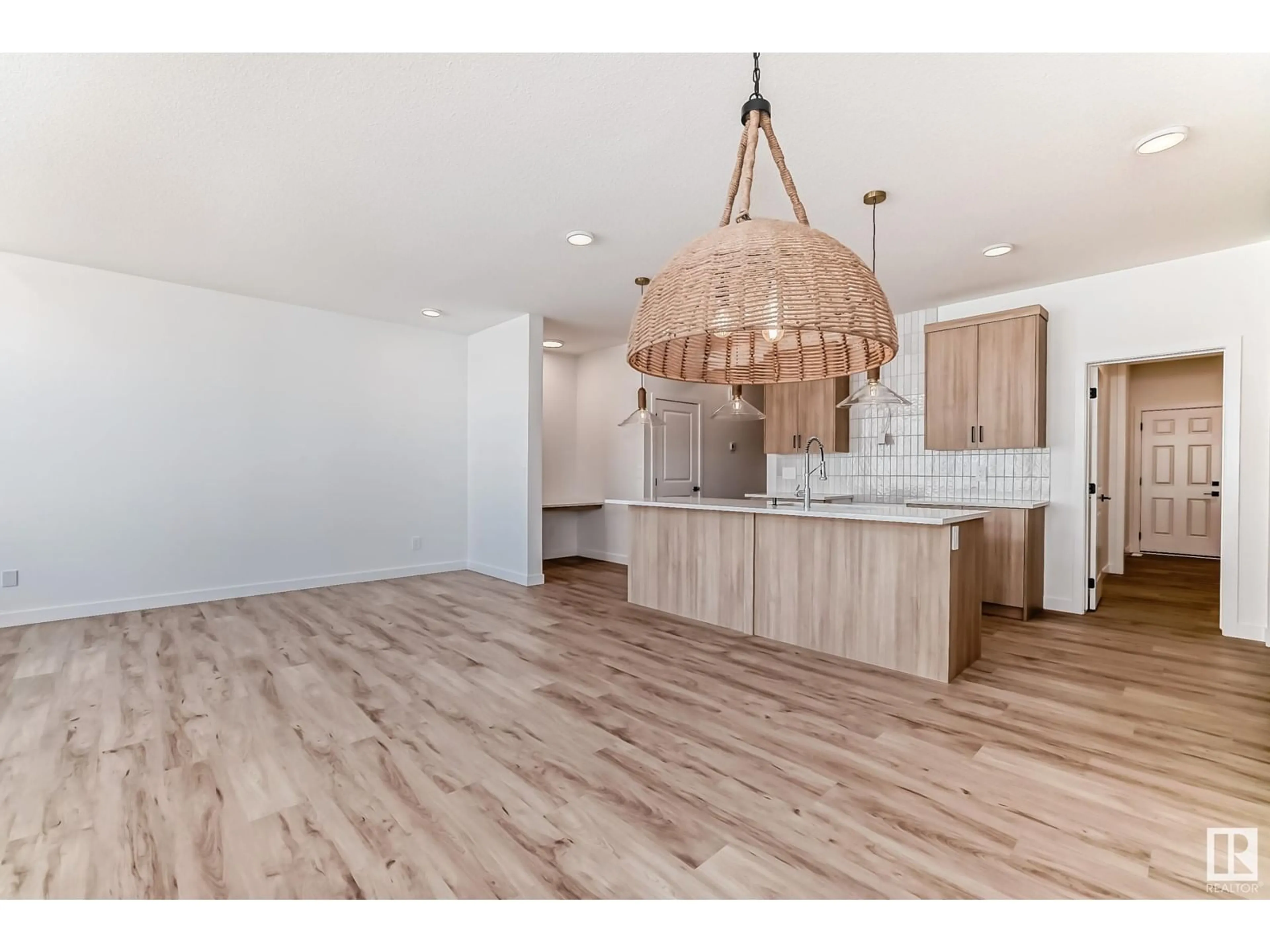 Open concept kitchen, wood/laminate floor for 16719 34 AV SW, Edmonton Alberta T6W5M2