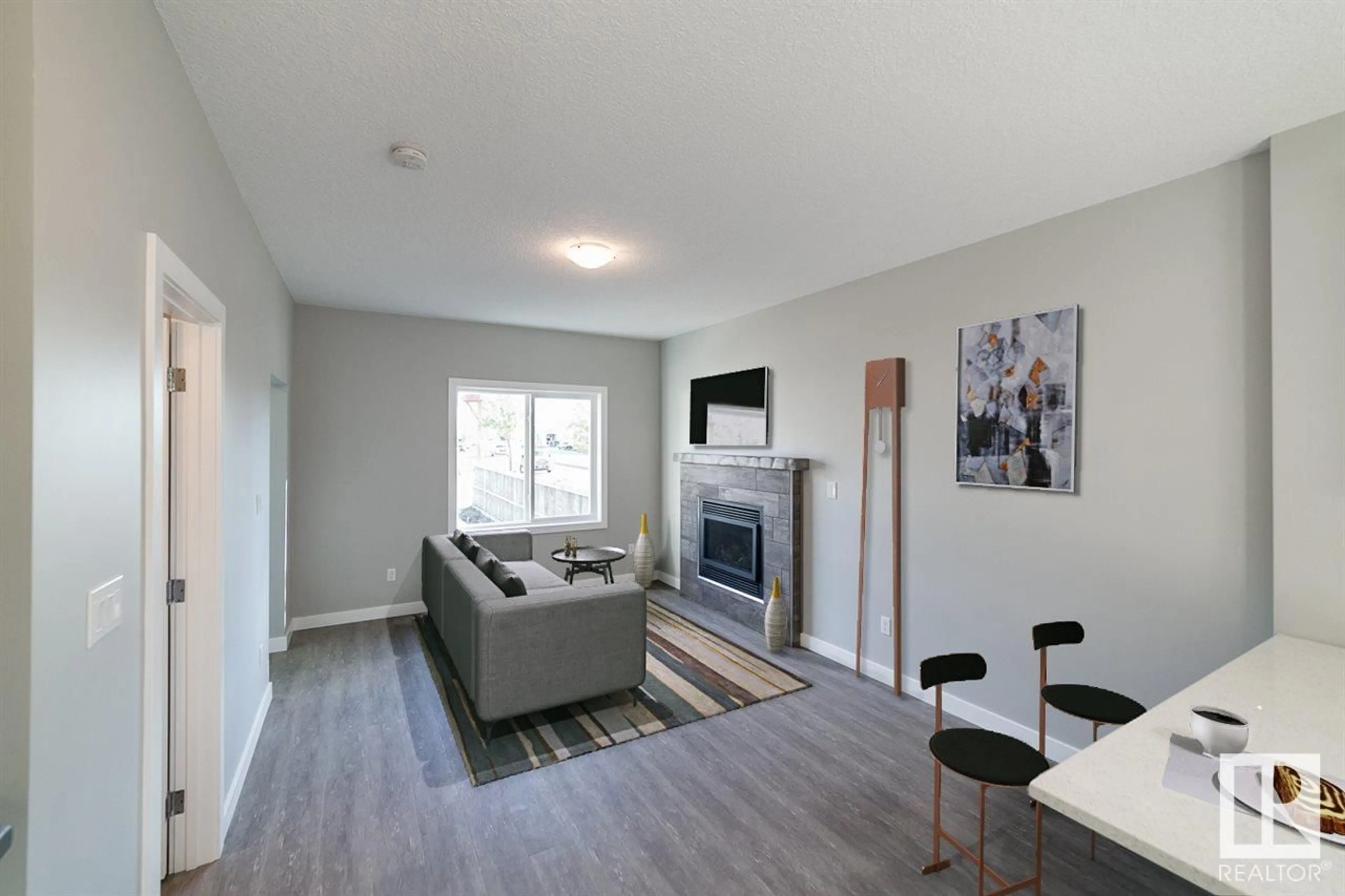 Living room with furniture, wood/laminate floor for 9859 73 AV NW, Edmonton Alberta T6E1B7