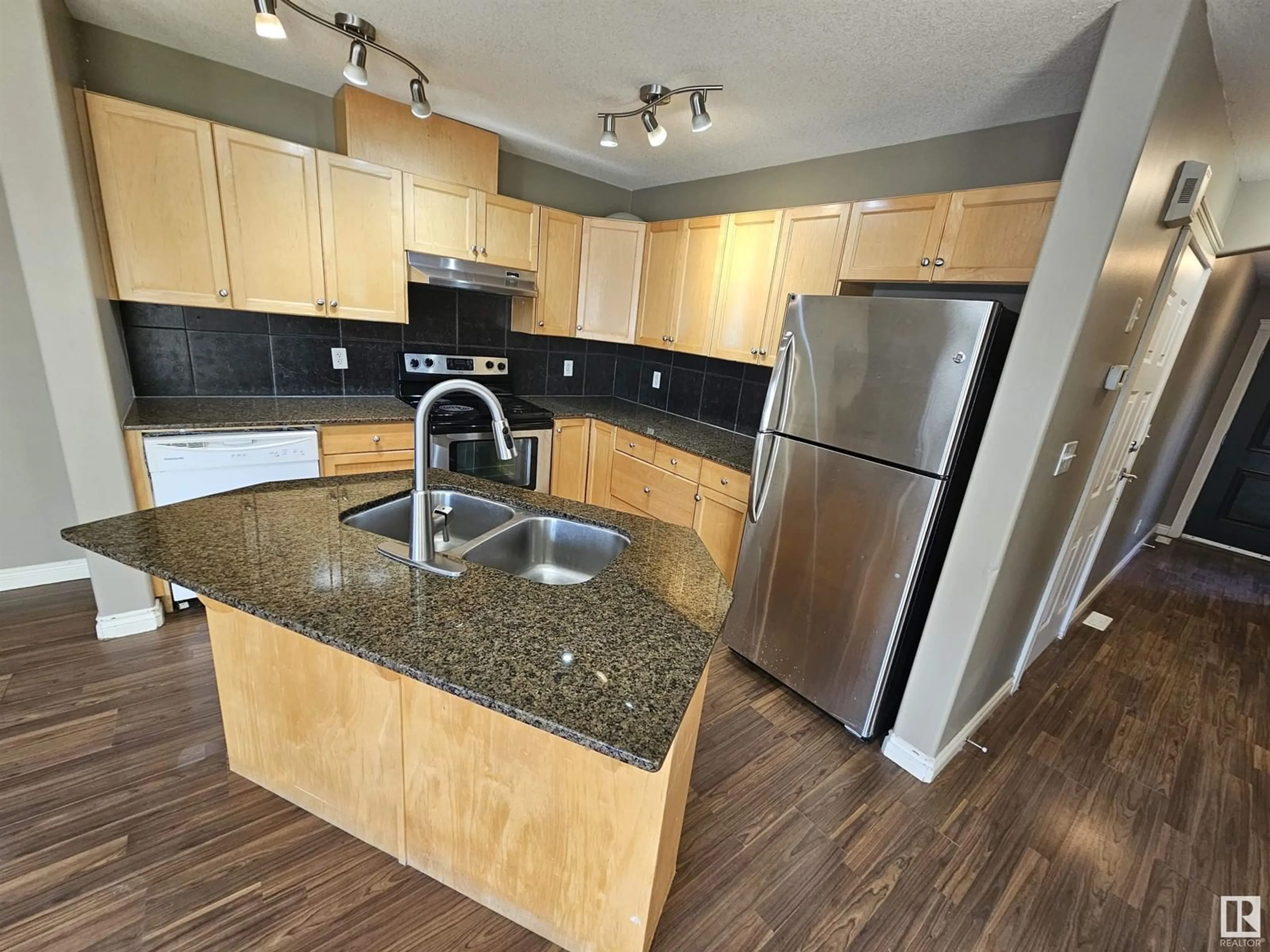 Open concept kitchen, wood/laminate floor for #150 101 Deer Valley DR, Leduc Alberta T9E0S3