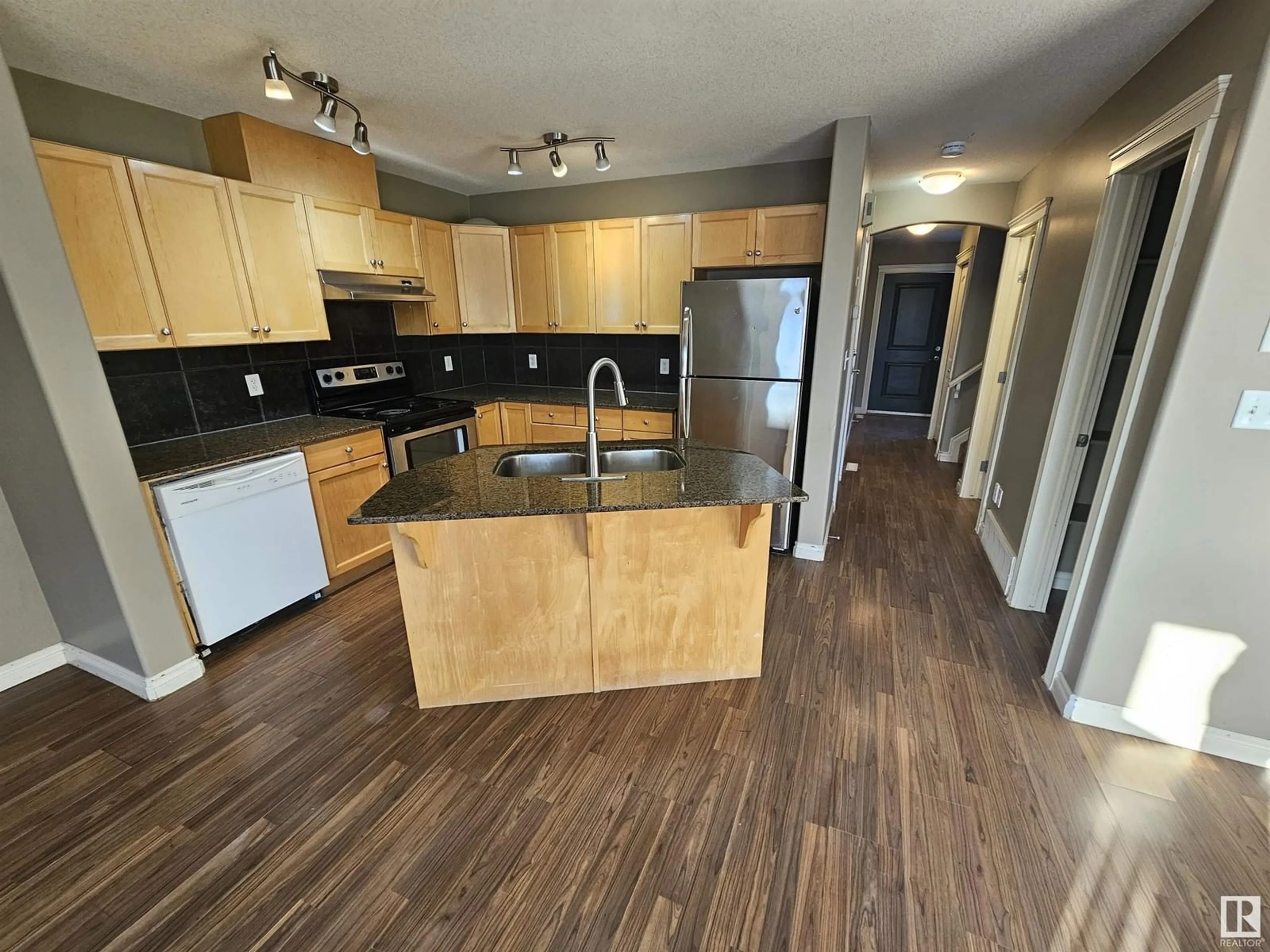 Open concept kitchen, wood/laminate floor for #150 101 Deer Valley DR, Leduc Alberta T9E0S3