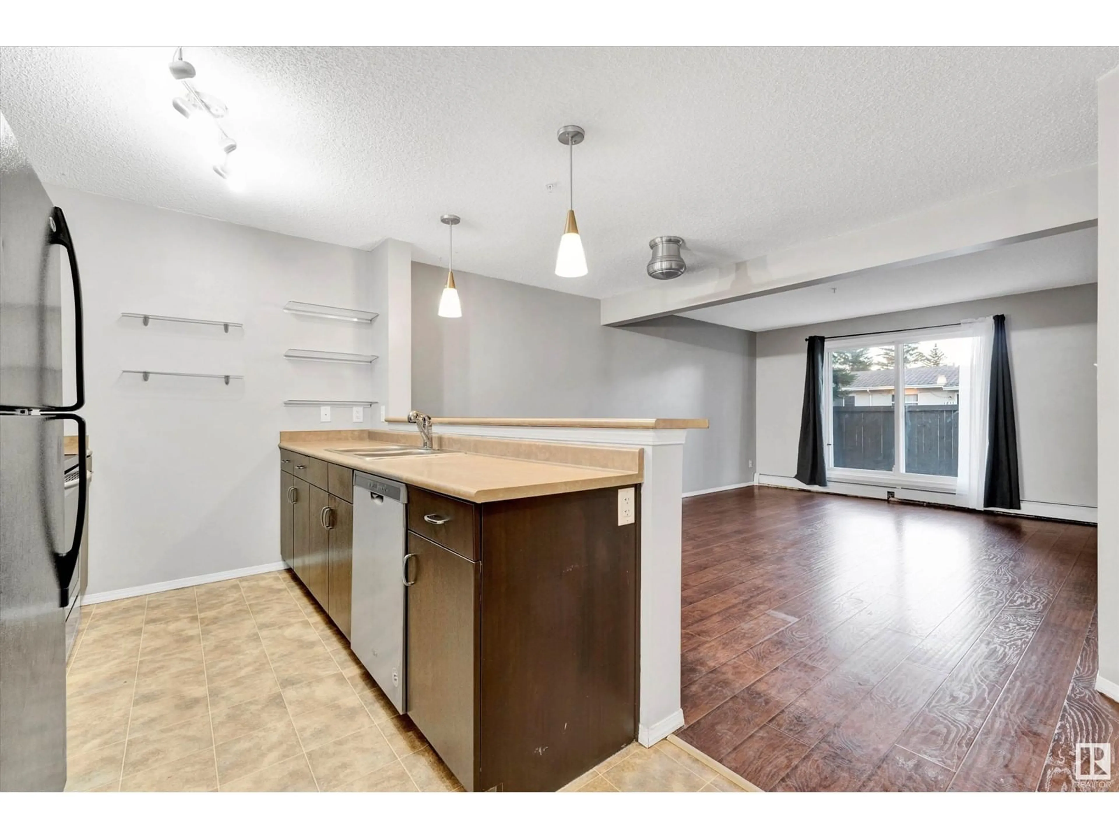 Open concept kitchen, wood/laminate floor for #134 1180 HYNDMAN RD NW, Edmonton Alberta T5A0P8