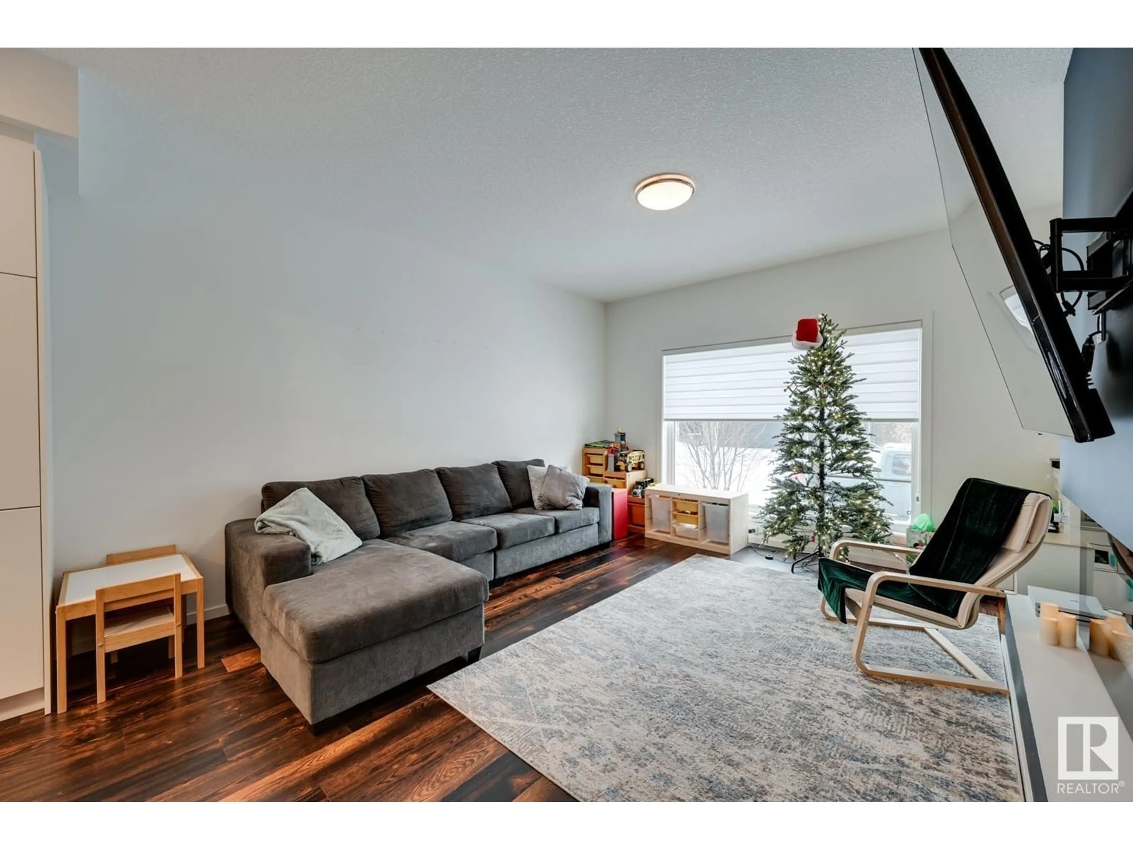 Living room with furniture, wood/laminate floor for 34 BRUNSWYCK CR, Spruce Grove Alberta T7X0Y9