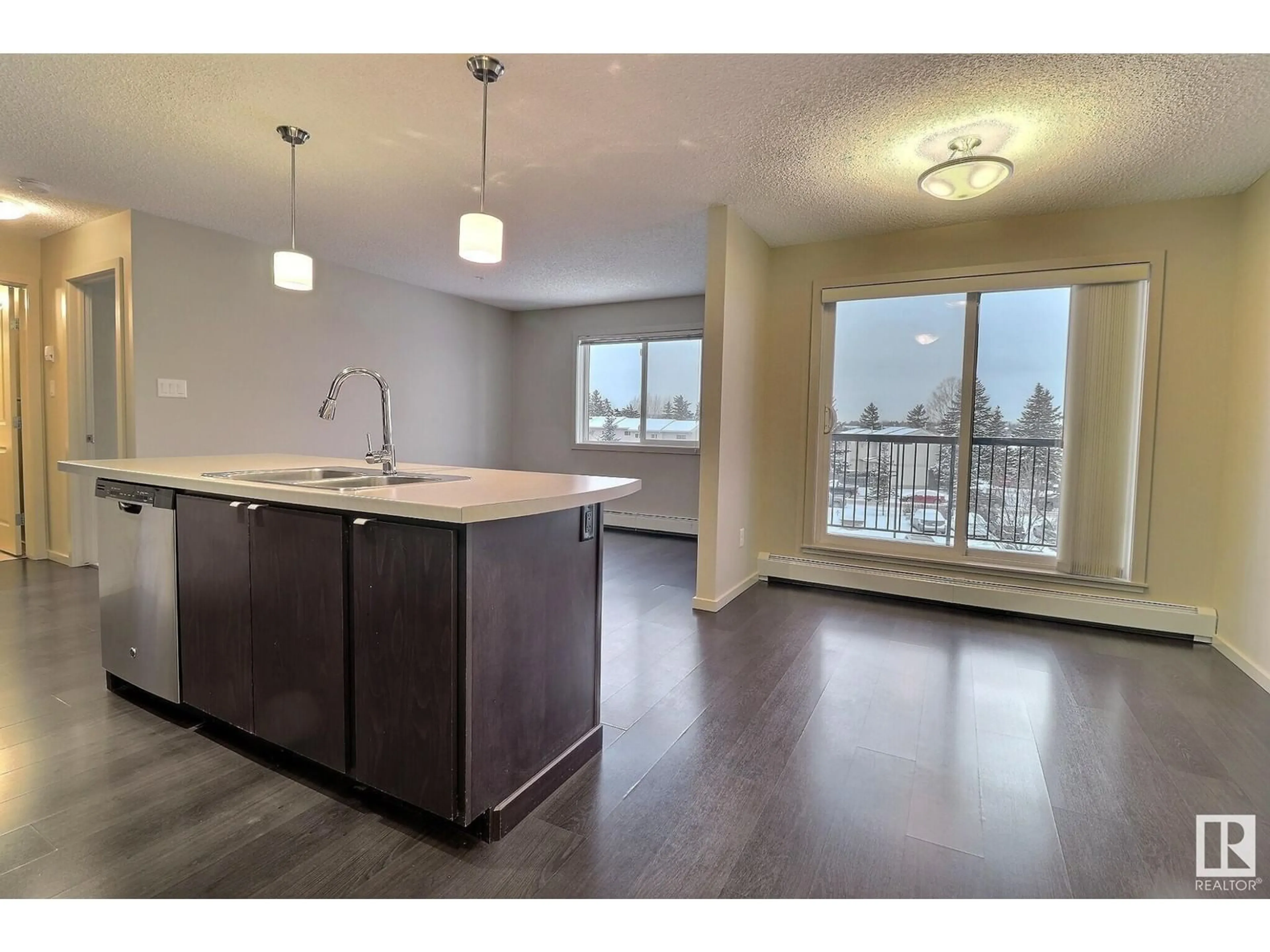 Open concept kitchen, wood/laminate floor for #347 1196 HYNDMAN RD NW, Edmonton Alberta T5W0A2