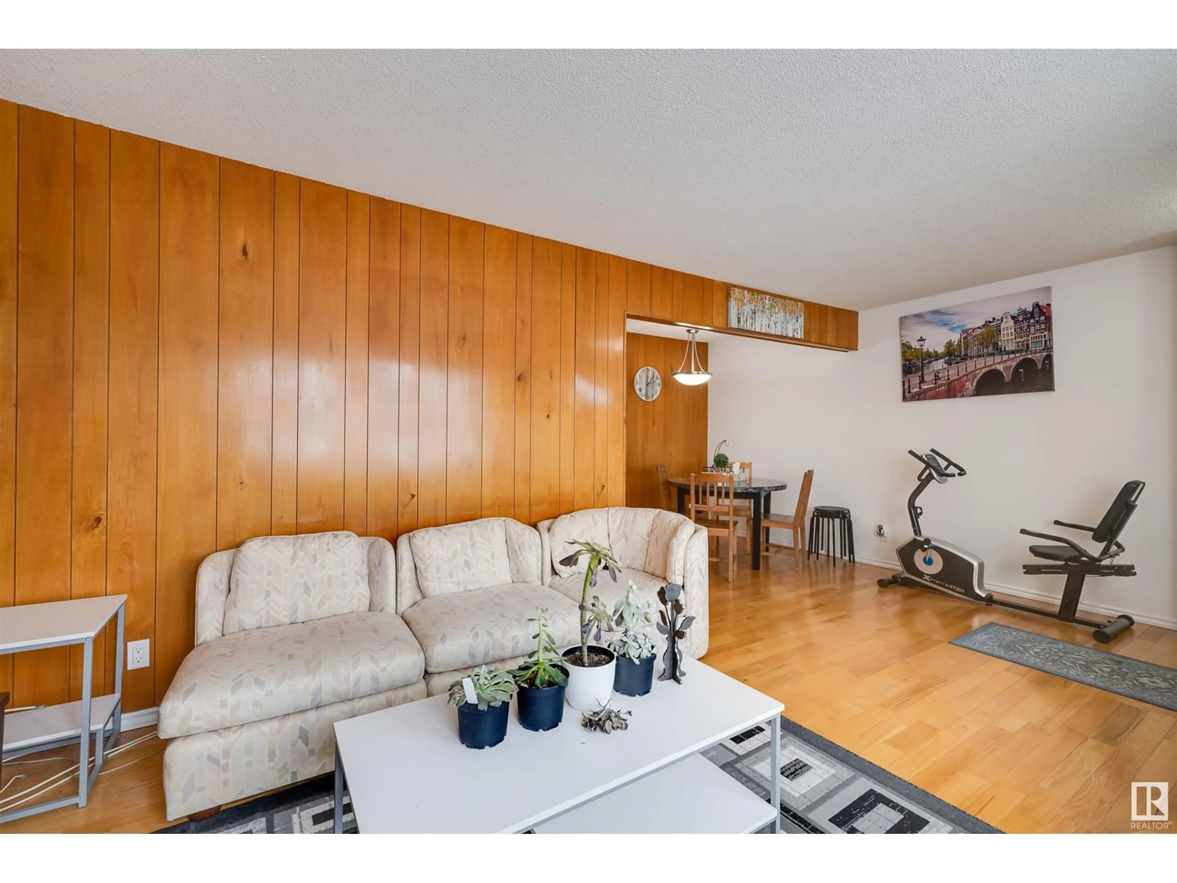 Living room with furniture, wood/laminate floor for 10632 51 AV NW, Edmonton Alberta T6H0L1