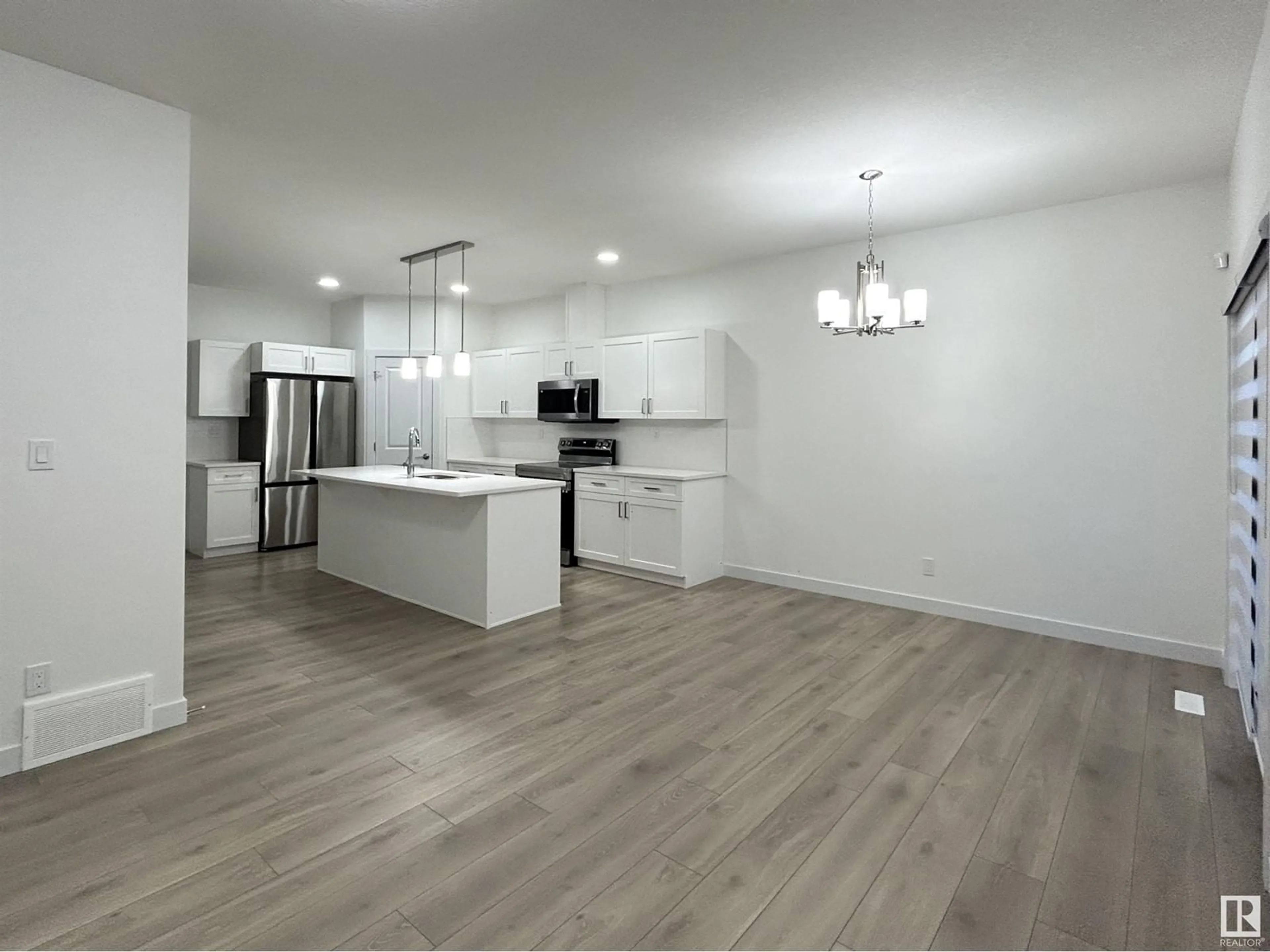 Open concept kitchen, wood/laminate floor for 19720 29 AV NW NW, Edmonton Alberta T6M1M2