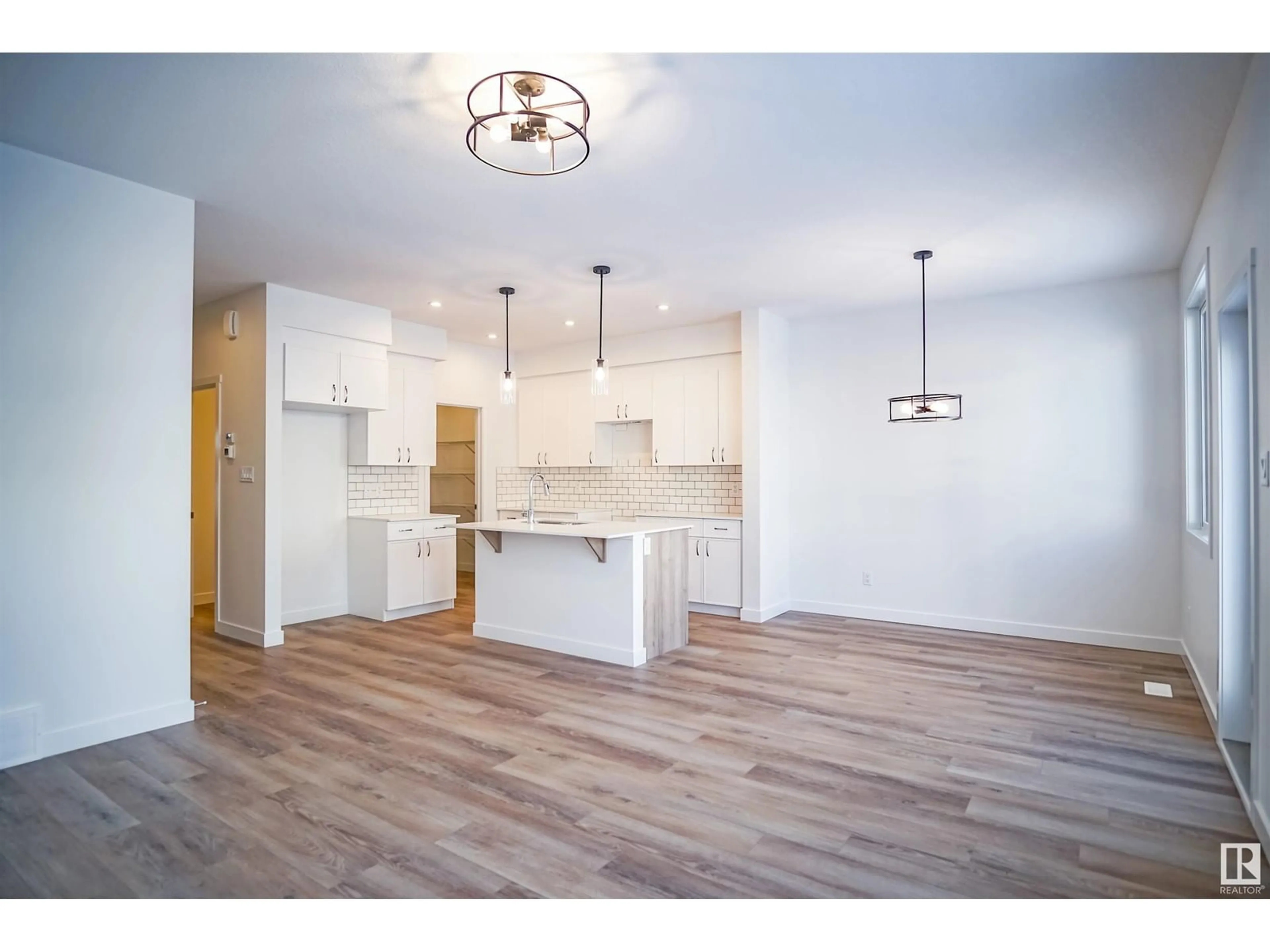 Open concept kitchen, wood/laminate floor for 17345 6A ST NE, Edmonton Alberta T5Y4E9