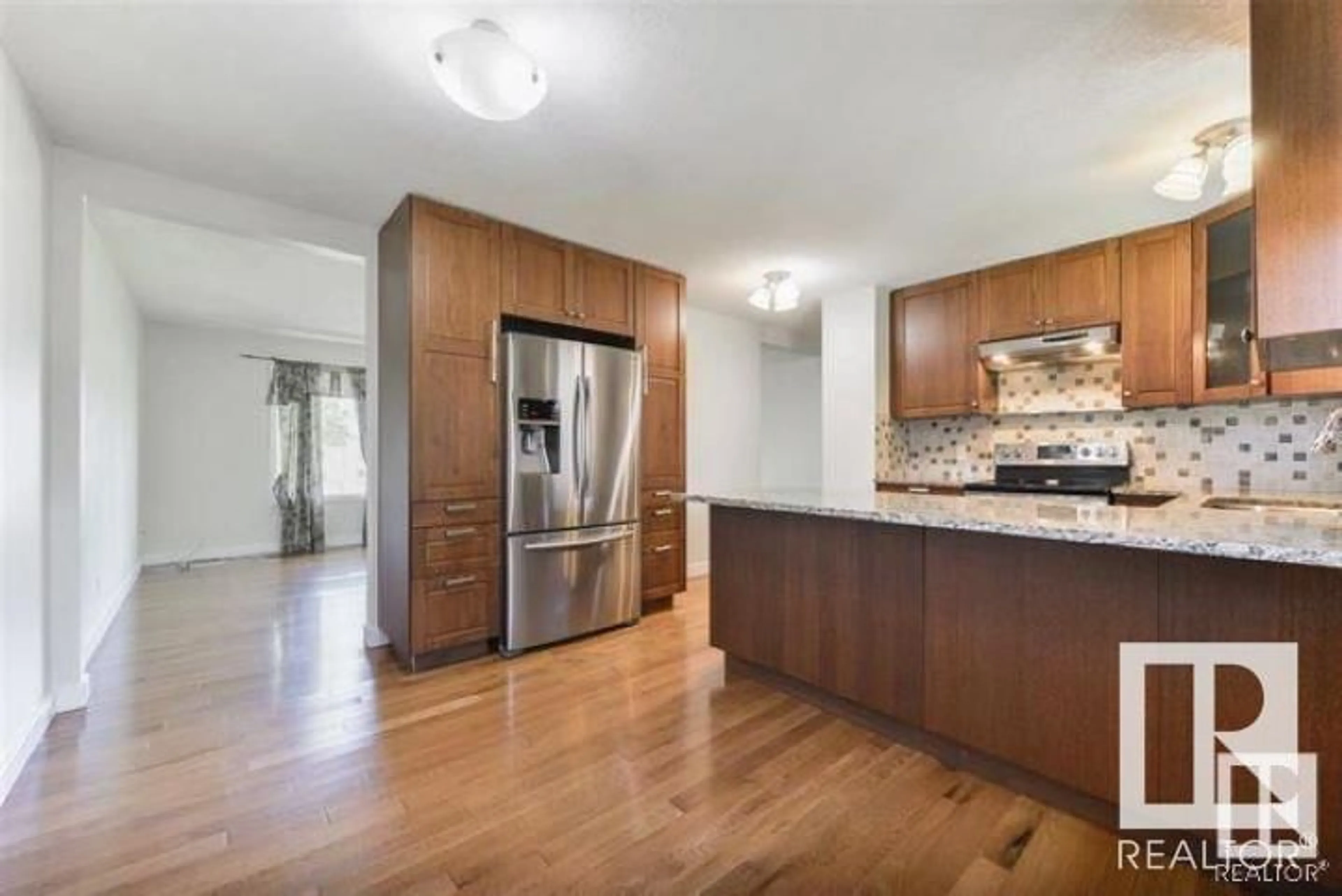 Open concept kitchen, wood/laminate floor for 9326 168 ST NW, Edmonton Alberta T5R2W3