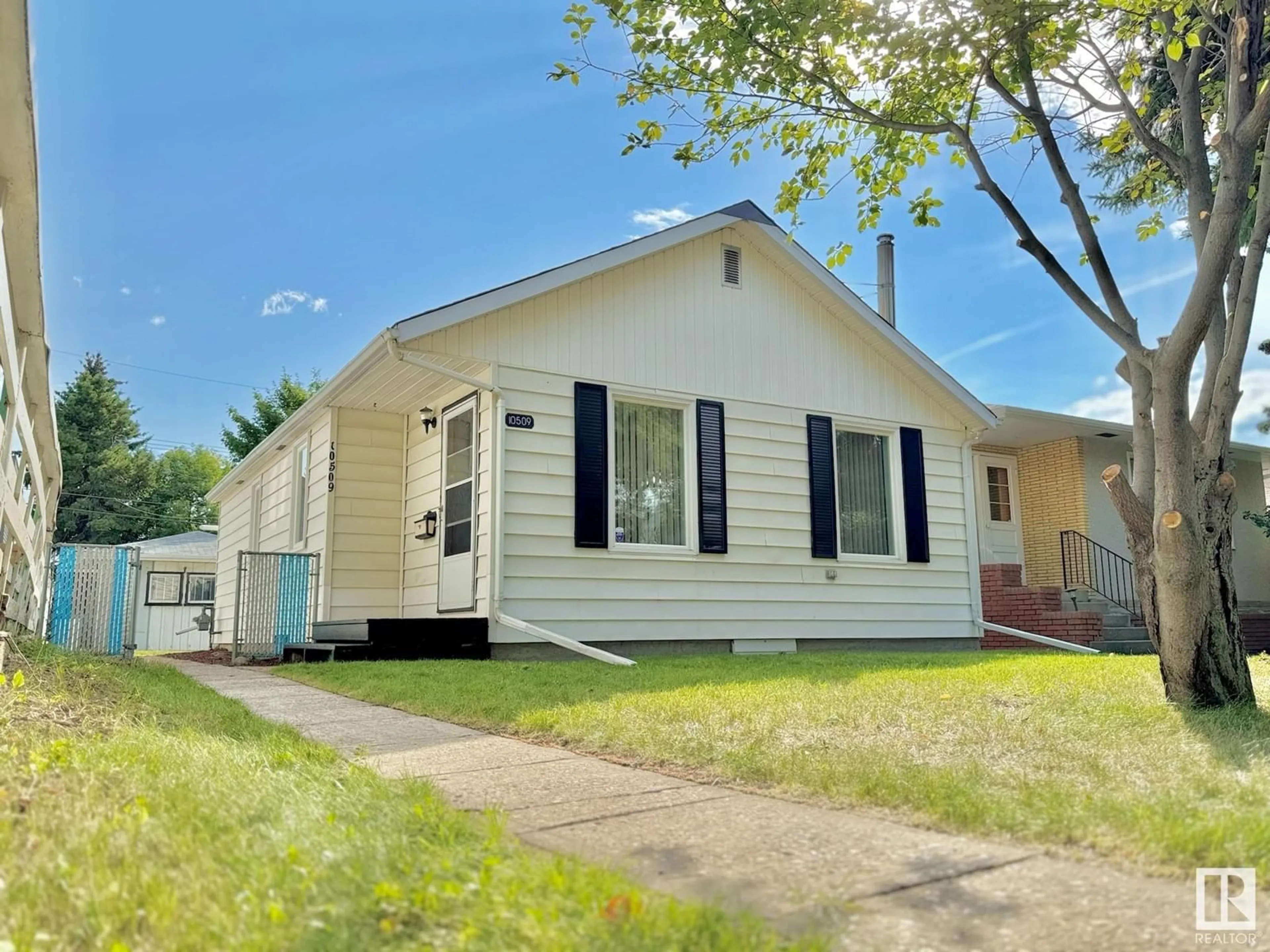 Home with vinyl exterior material, street for 10509 63 AV NW, Edmonton Alberta T6H1P5